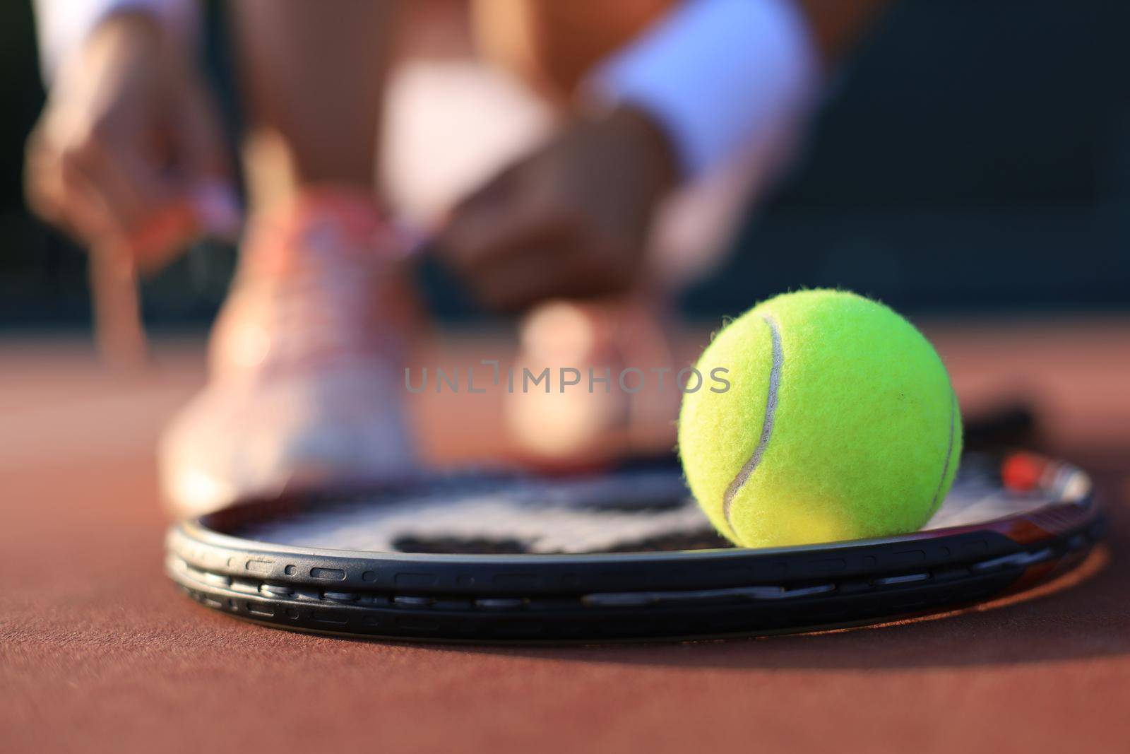 Tennis racket and the ball on tennis court. by tsyhun