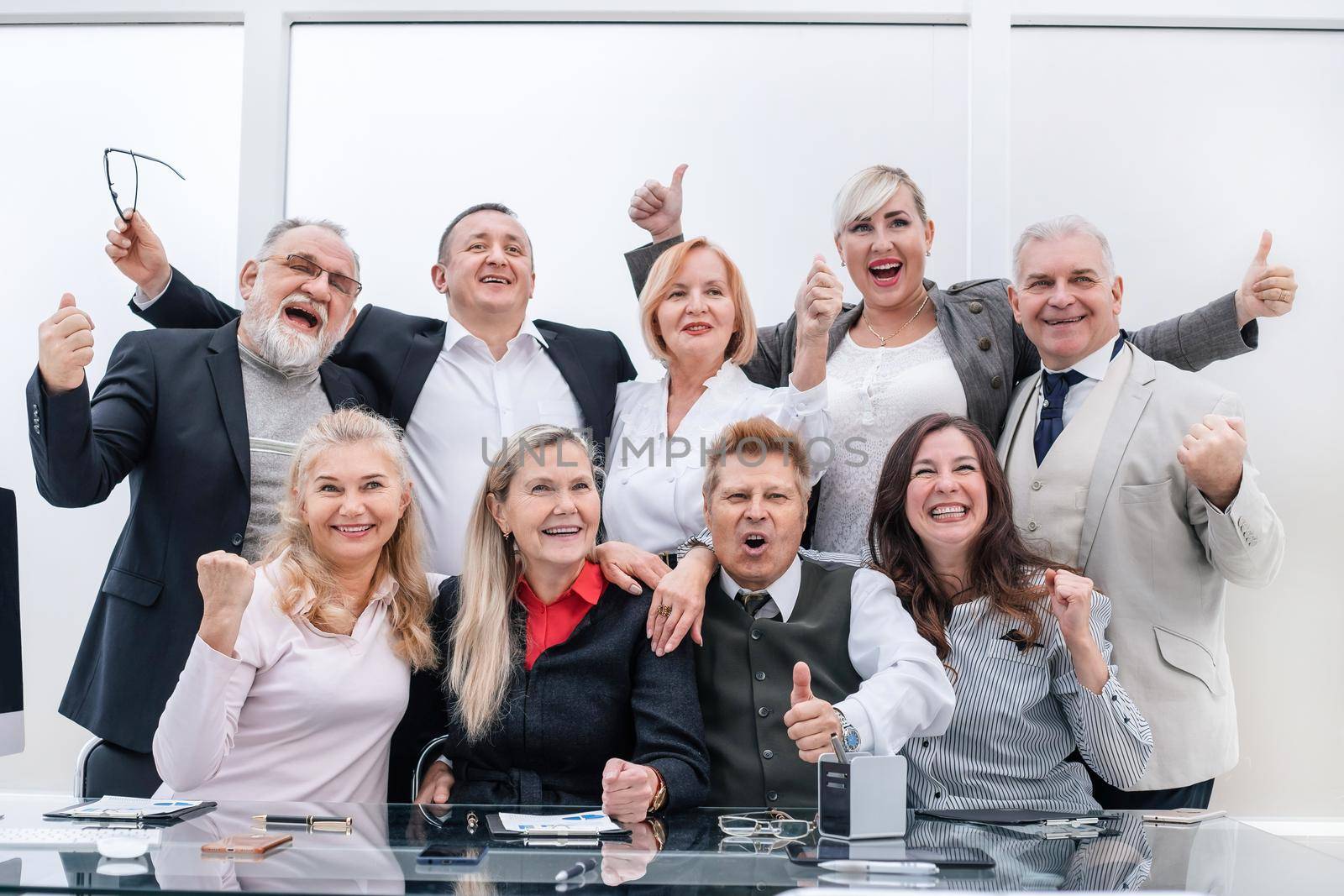 happy group of professional professionals showing thumbs up. the concept of professionalism