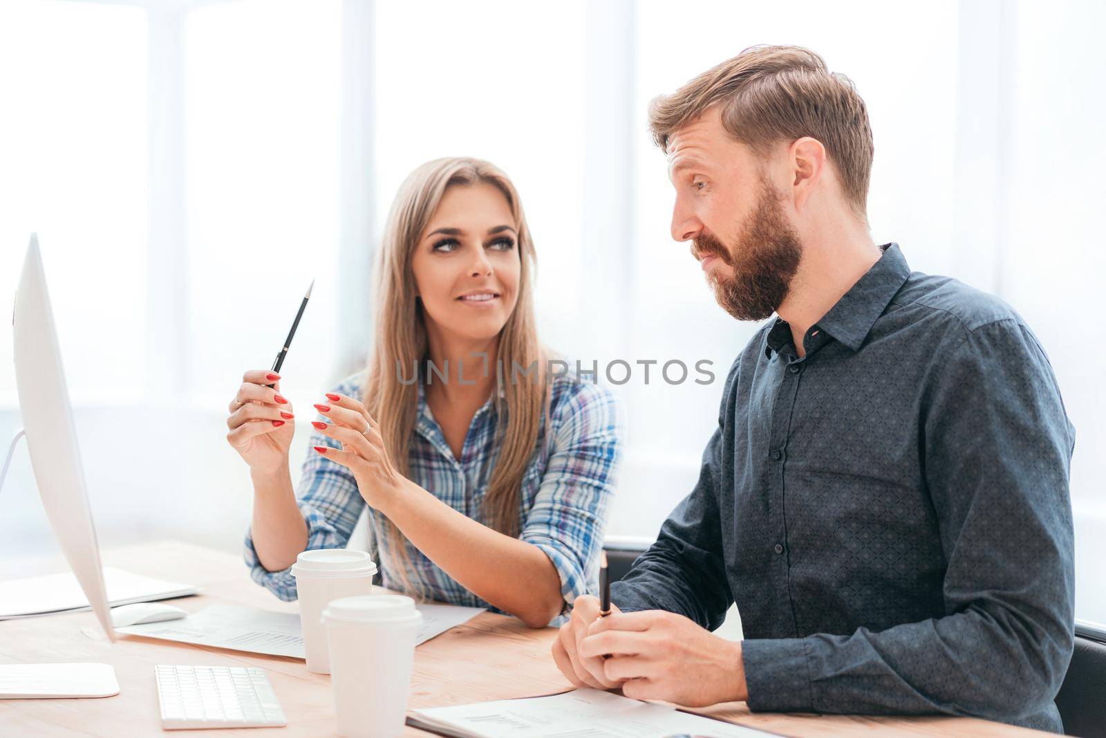 employees discussing online data in the office. office weekdays