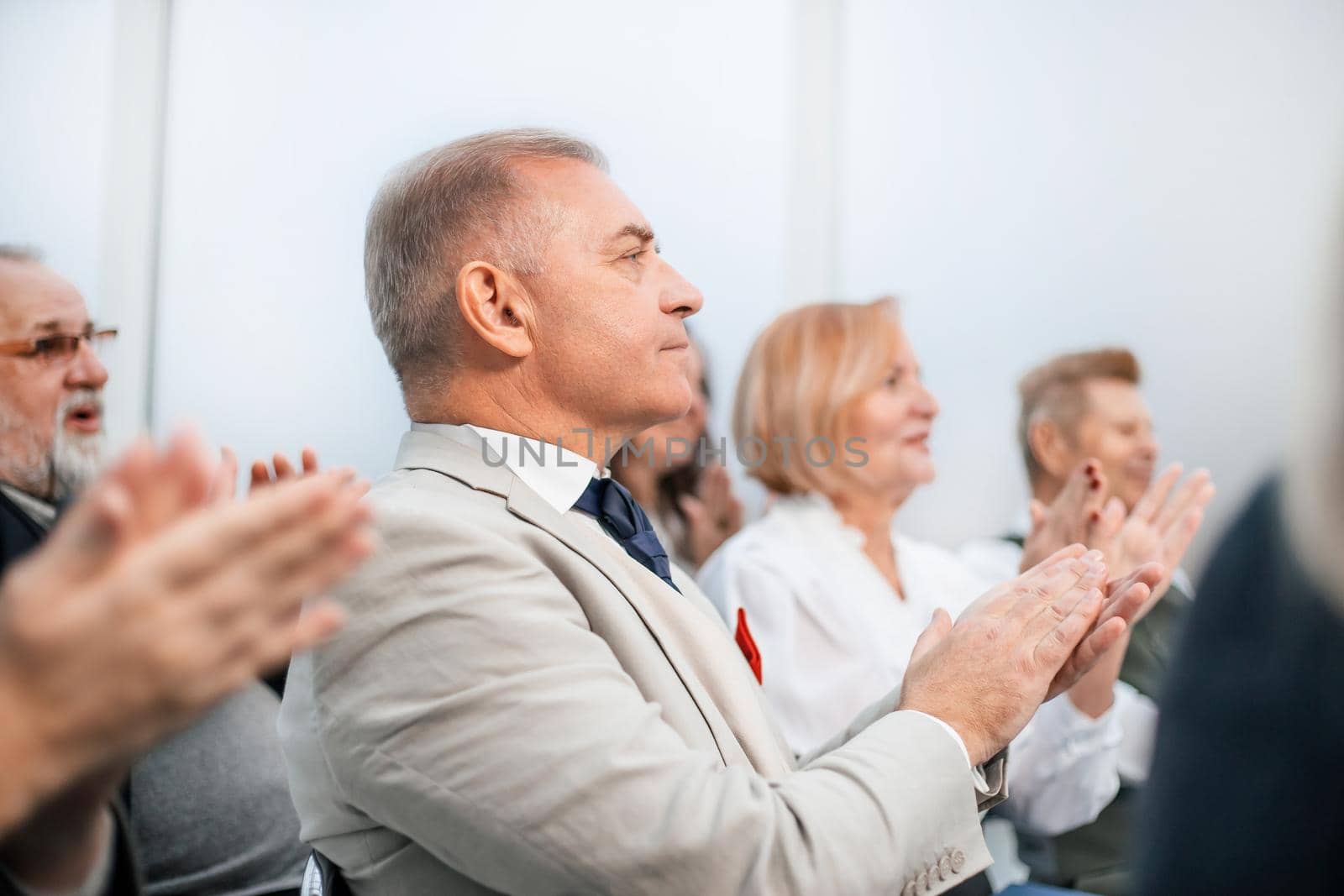 close up. a group of business people applaud during a business seminar. business and education
