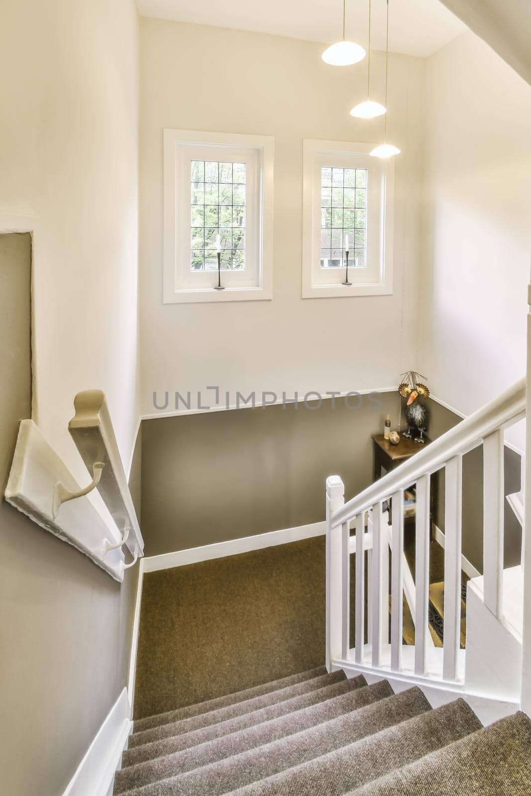 Beautiful staircase with gray carpet and comfortable handrails