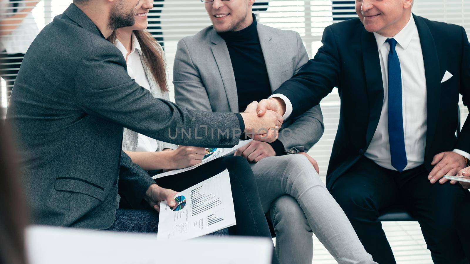 business partners shaking hands at a work meeting. business concept