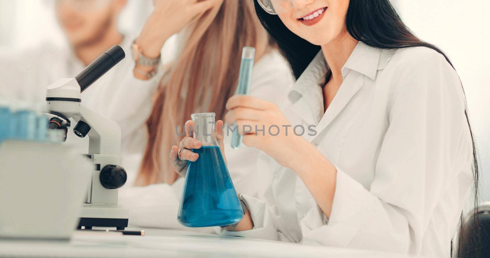 group of young scientists conduct research in the laboratory . science and health