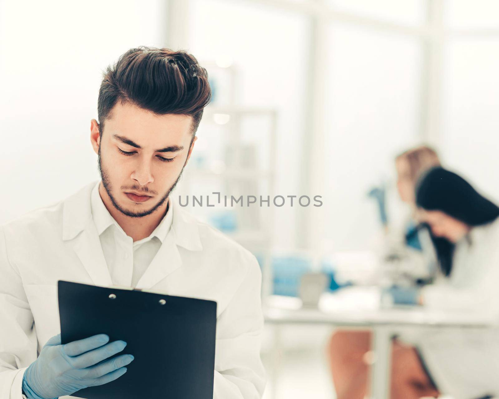 close up. a scientist doing writes the results of an experiment to a laboratory journal . photo with copy space