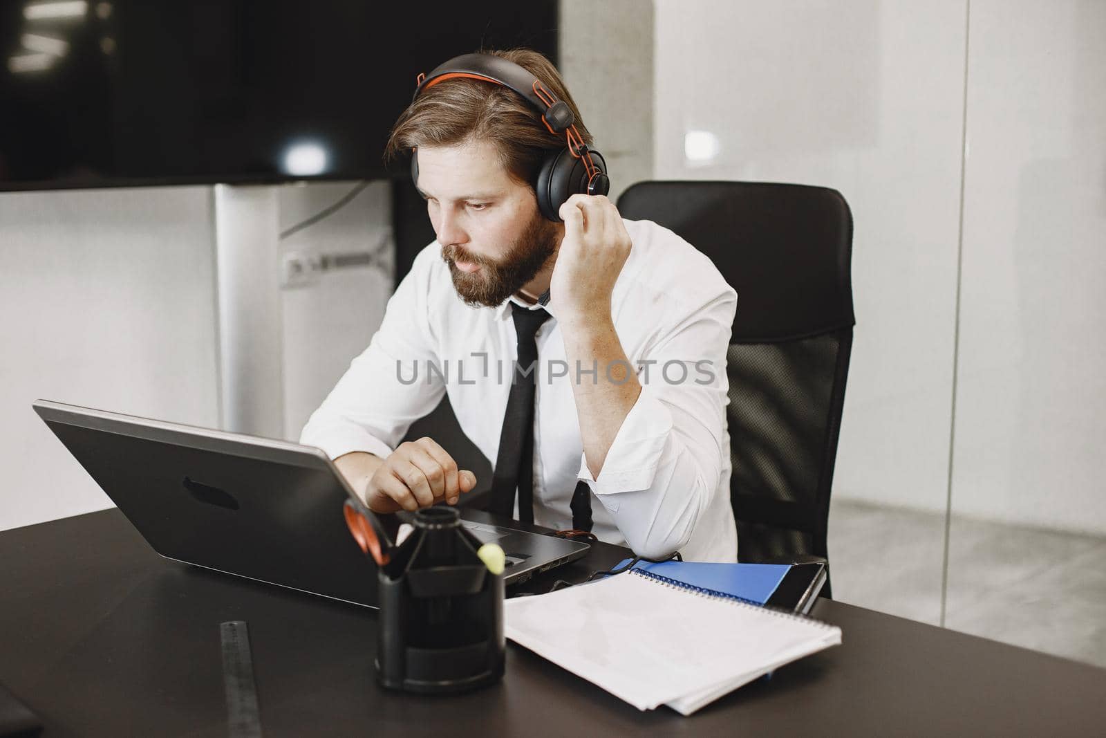 Handsome man in a white shirt. Businessman working online.