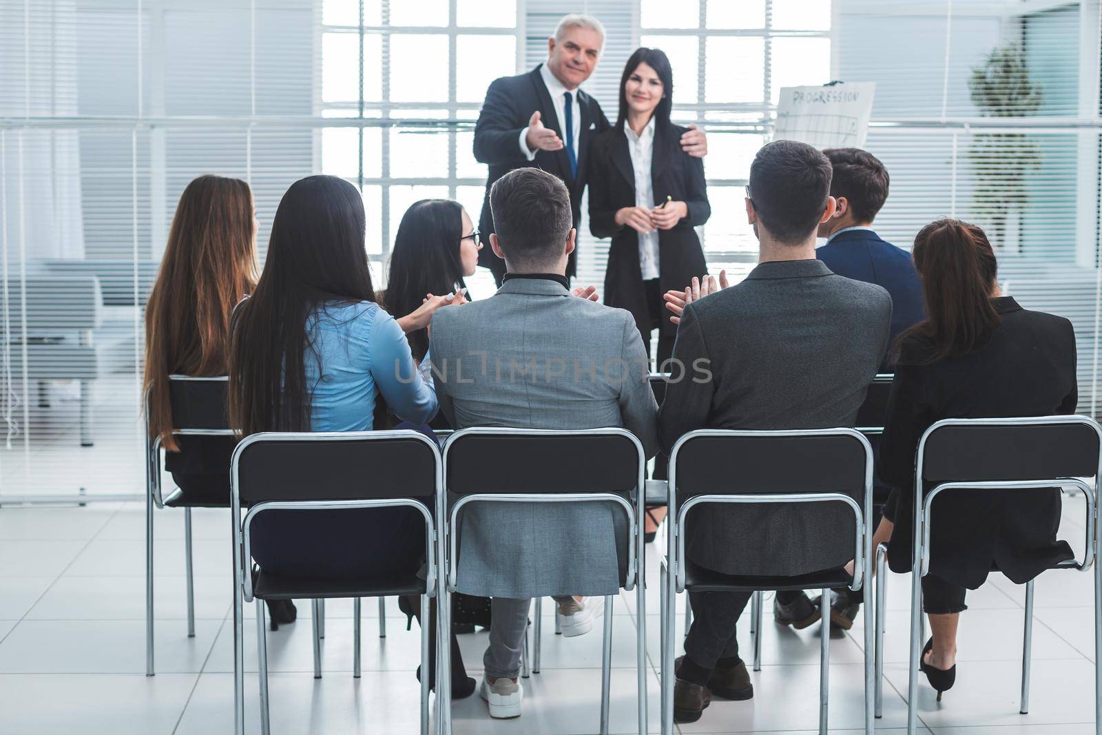 boss representing a young specialist during a work meeting. success concept