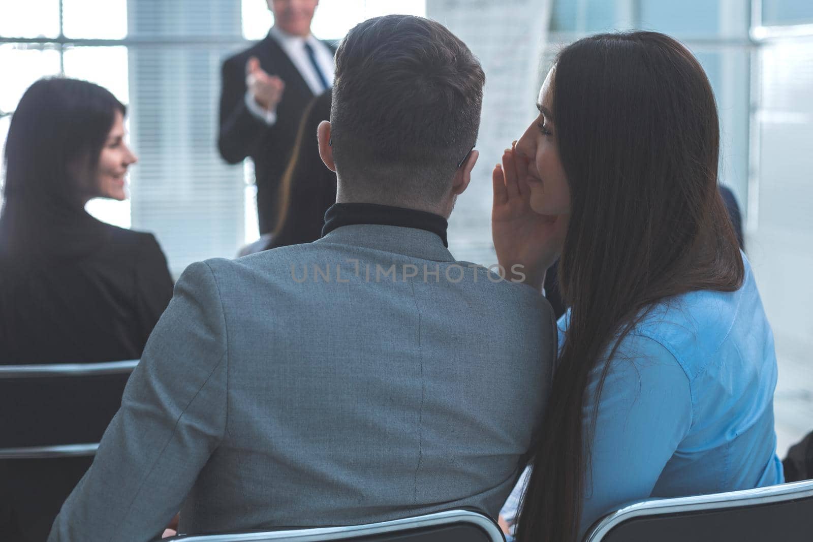 rear view. colleagues discuss something during a business presentation