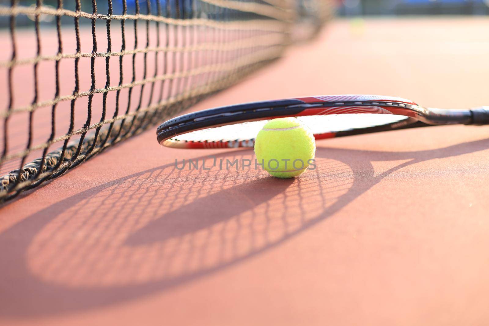 Tennis racket and the ball on tennis court. by tsyhun