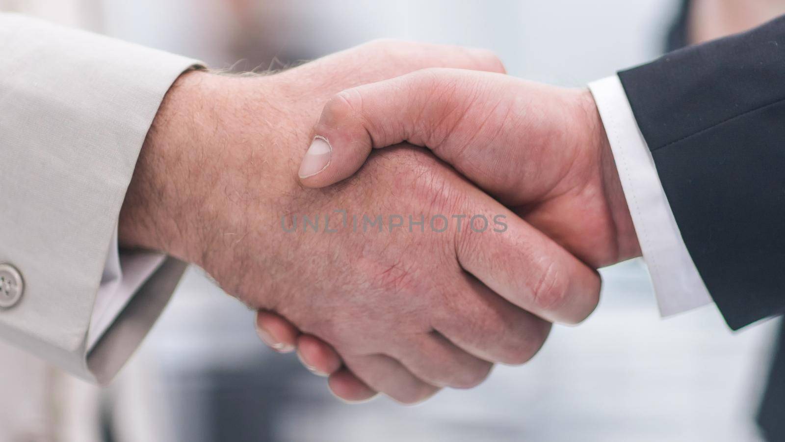 close up. business handshake on the background of the office. business concept