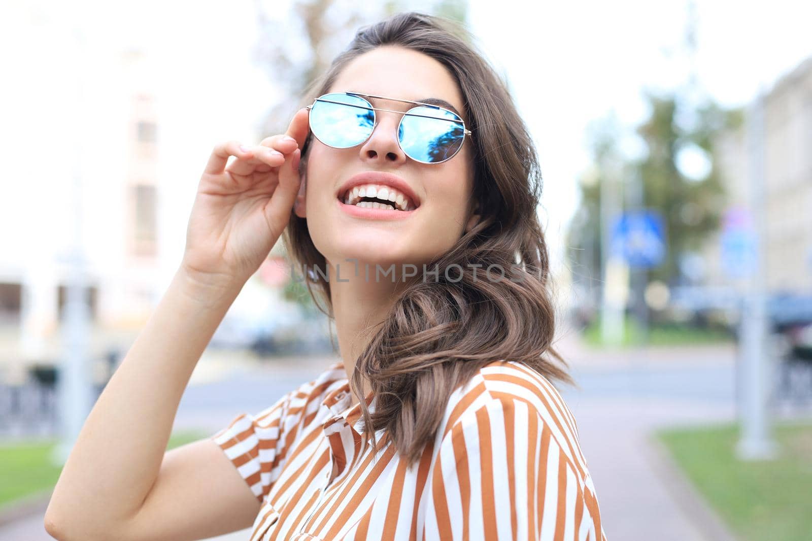 Smiling happy young beautiful woman walking outdoors