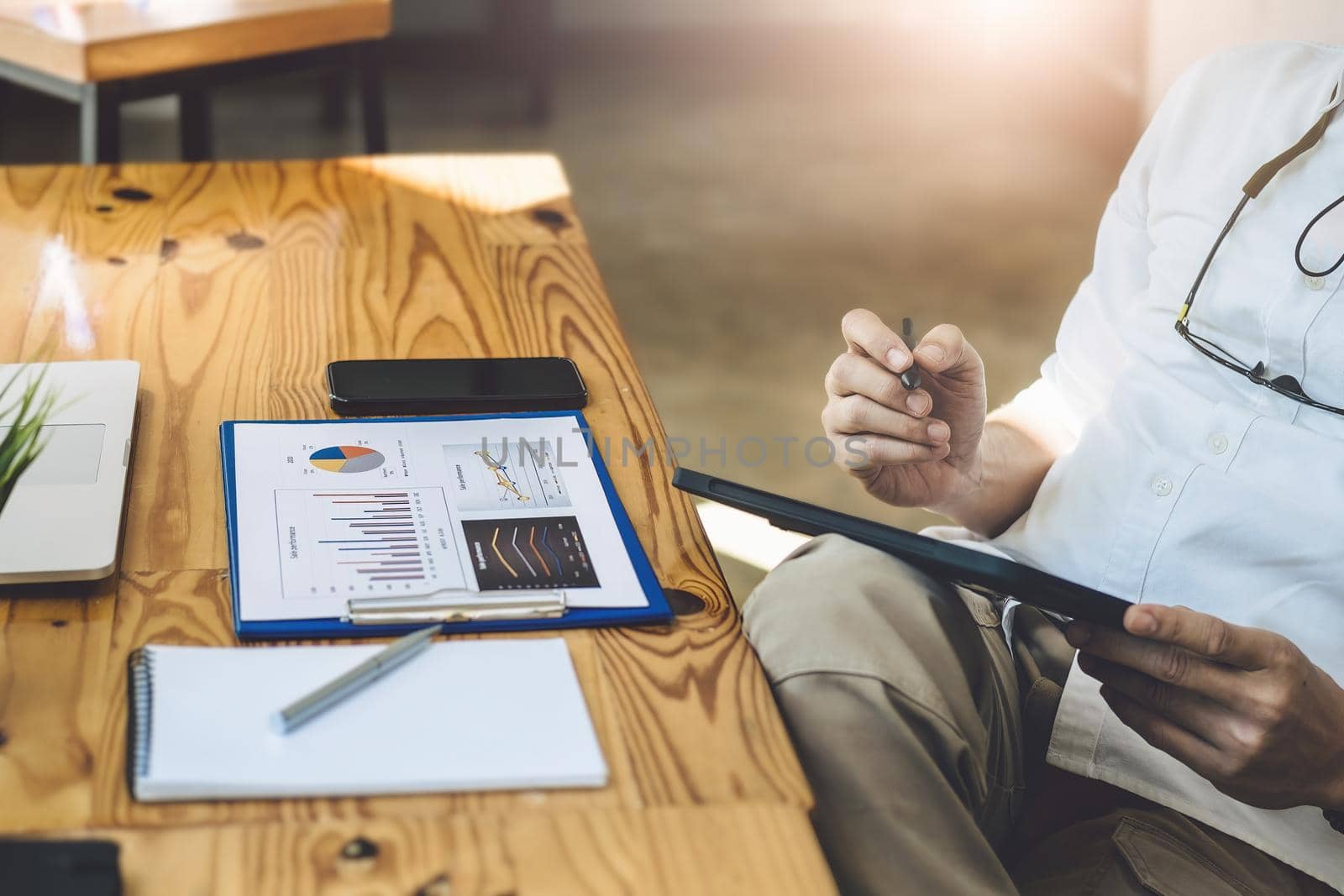 Financial Freedom, a stock analyst holding a pen pointing at a tablet Analyze the stock market to make a profit for your own portfolio. by Manastrong