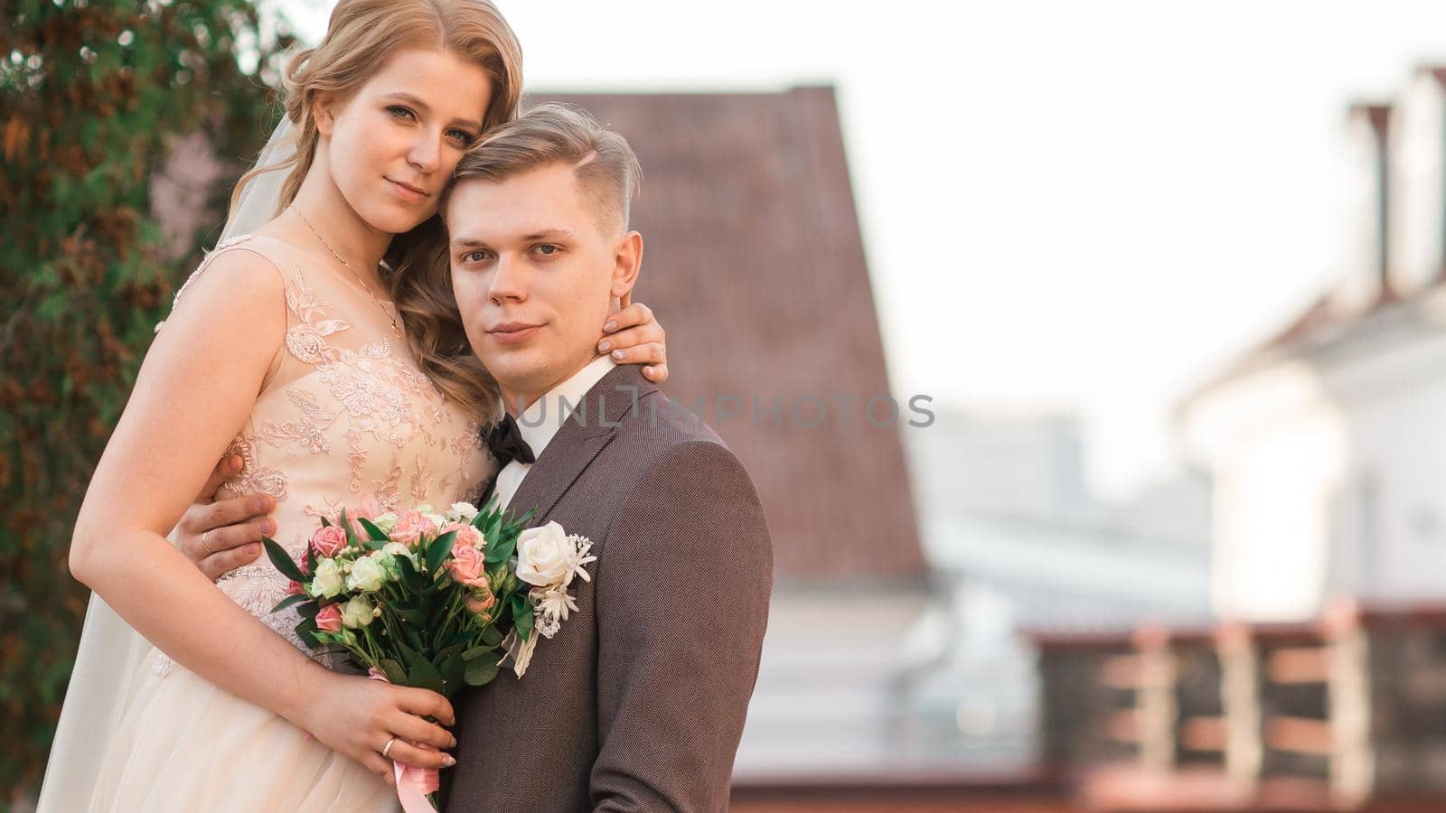 beautiful couple of newlyweds standing on the bridge. photo with copy space