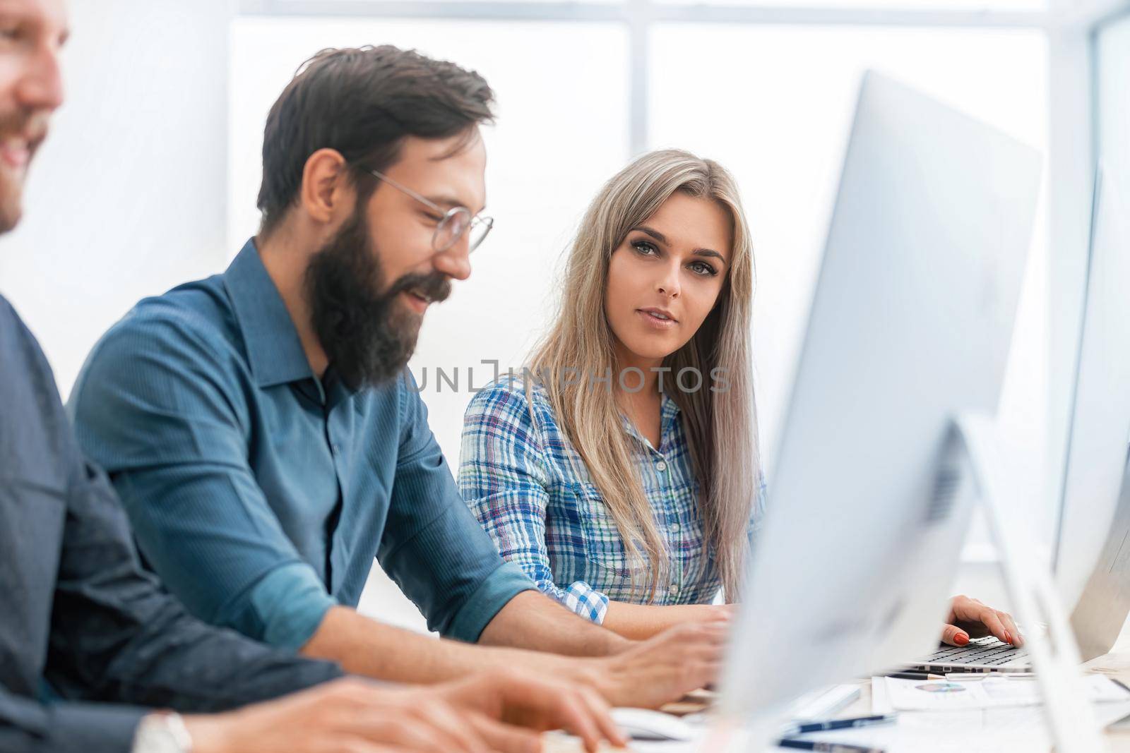 close up. young employees work on personal office computers. people and technology