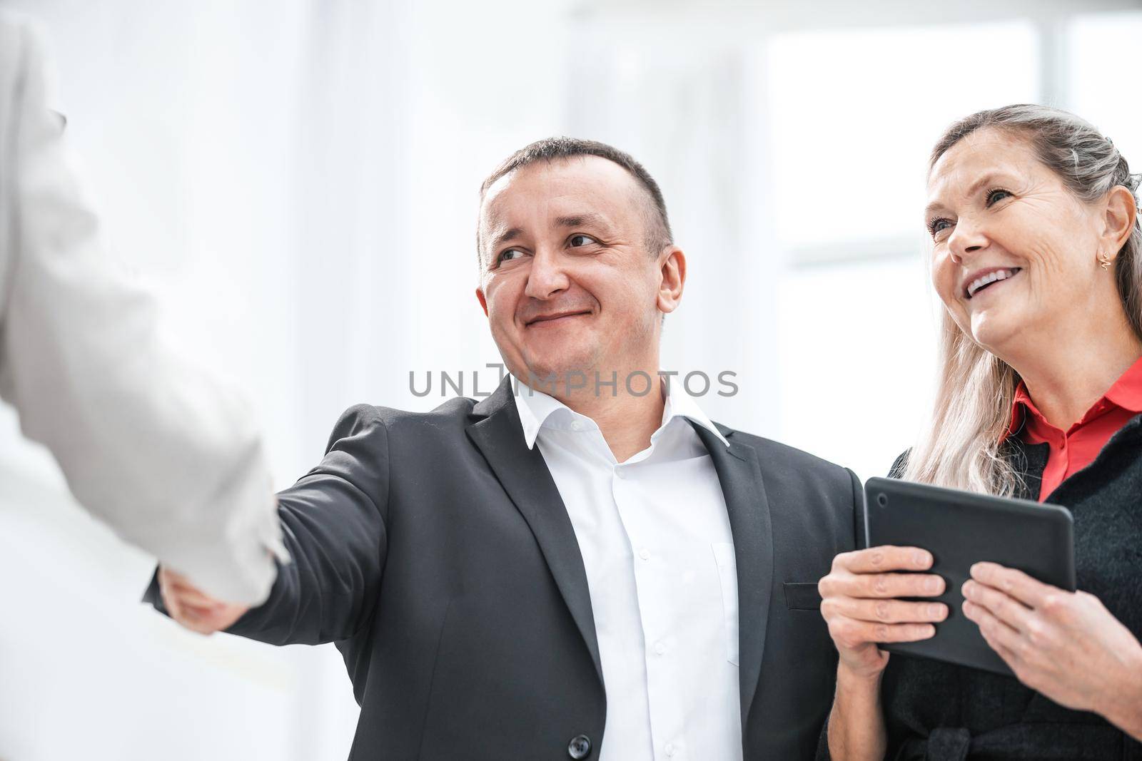 close up. smiling businessman shaking hands with his business partner. the concept of cooperation