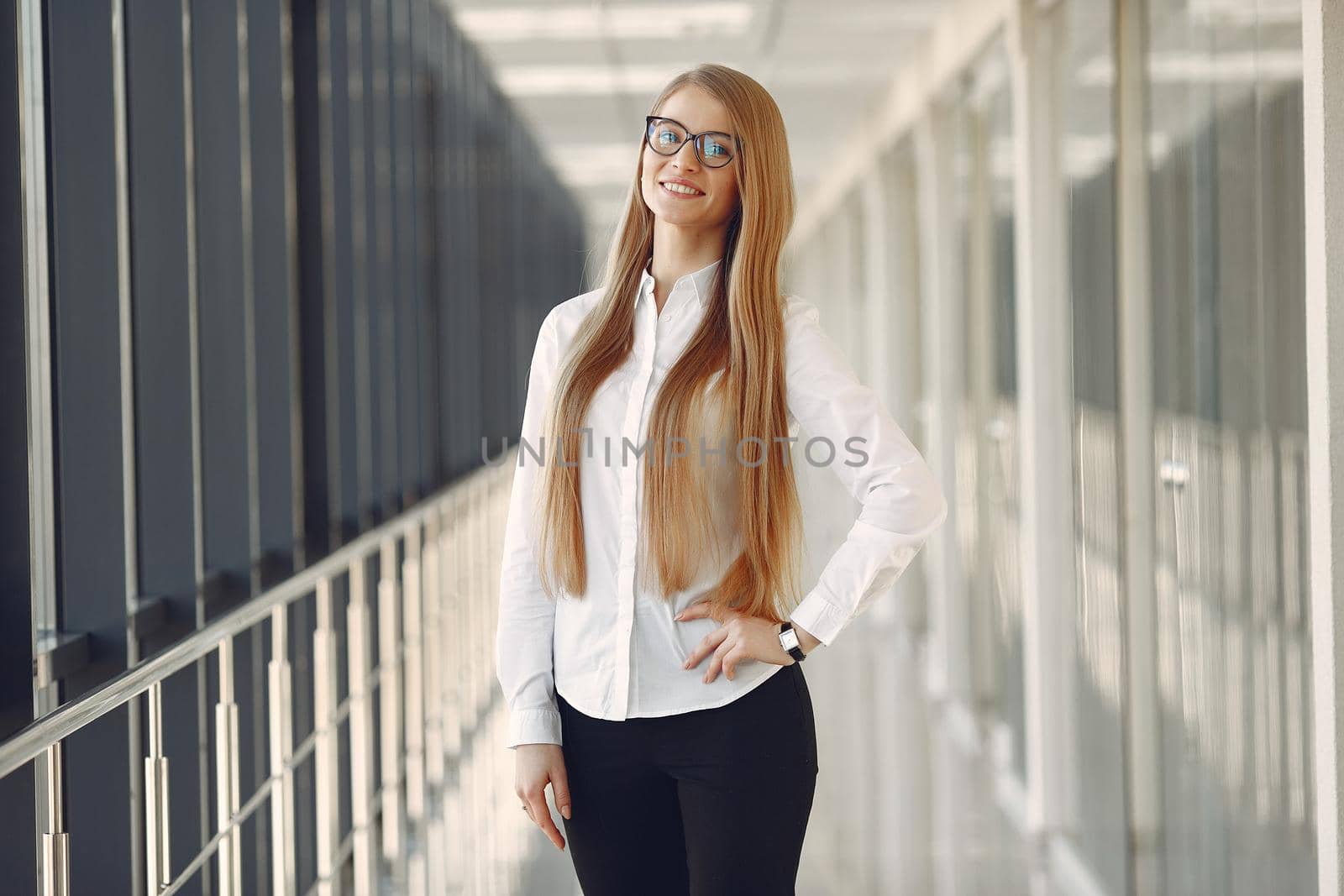 Girl in the office. Woman in a white blouse. Lady in a glasses.