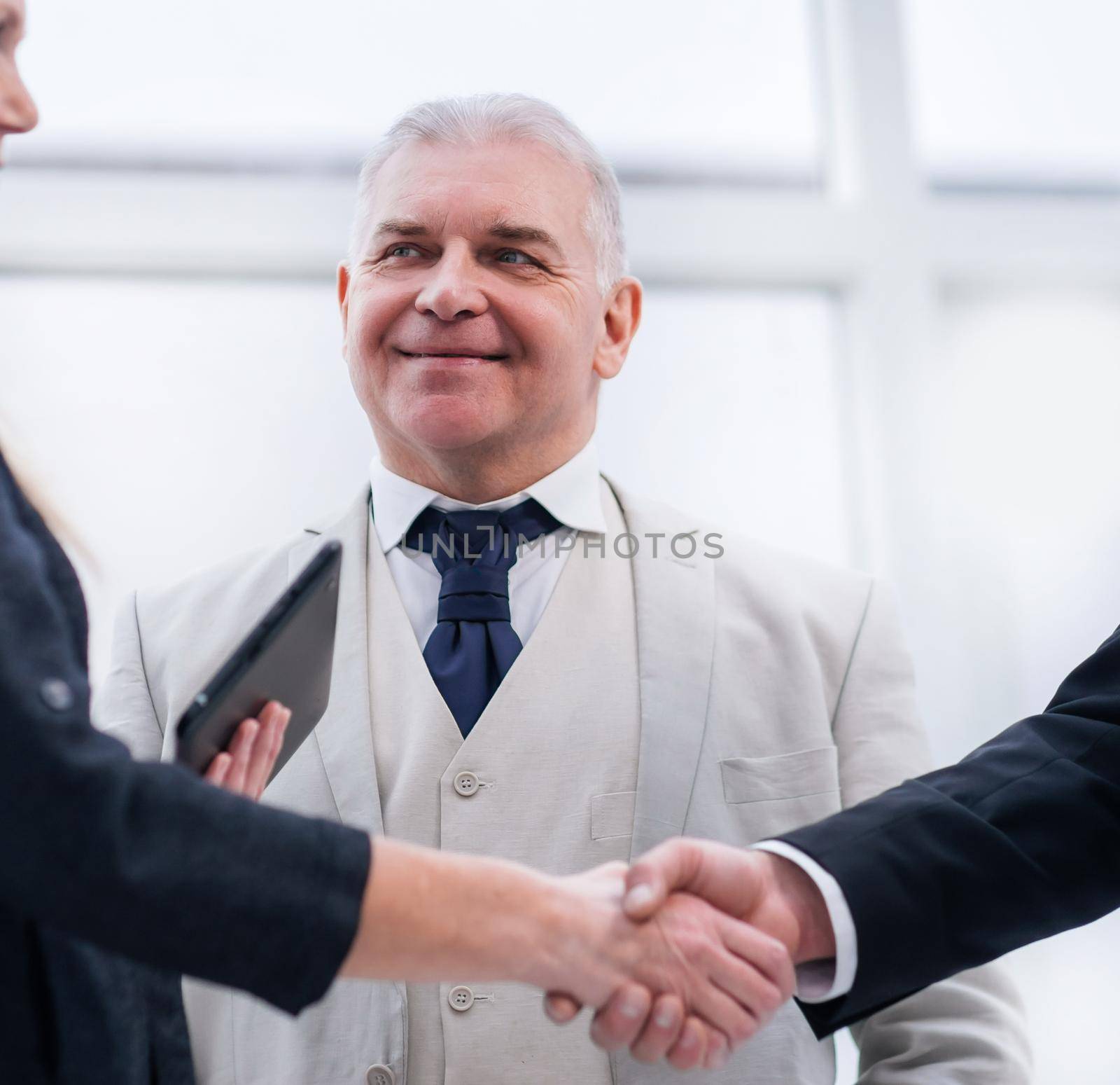 close up. smiling business people shaking hands. office weekdays