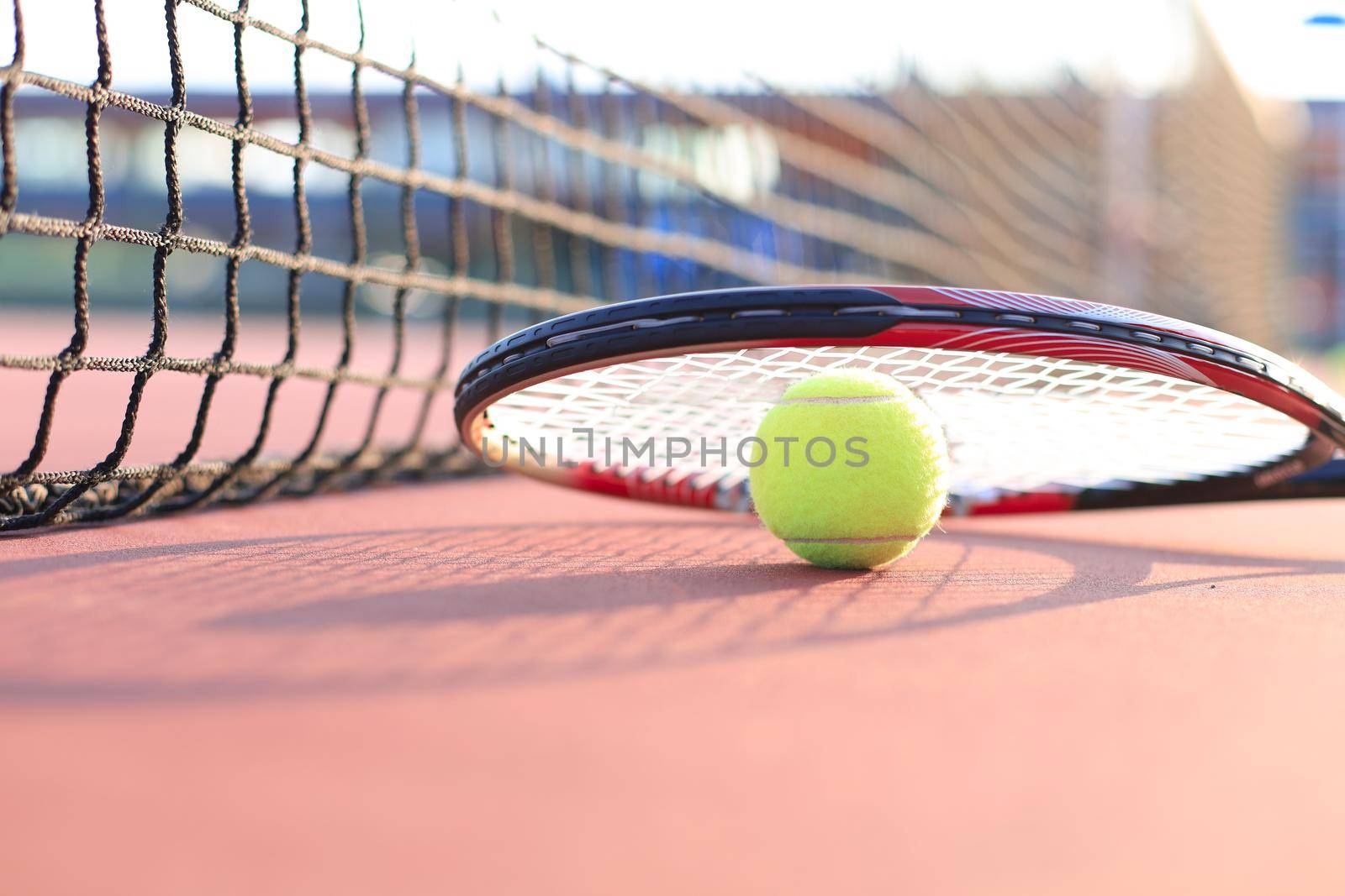 Tennis racket and the ball on tennis court. by tsyhun