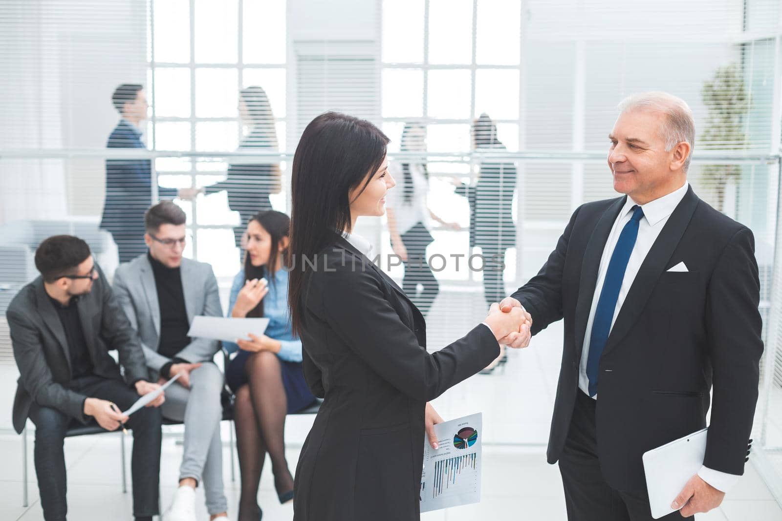 boss and the assistant discuss a business document. office workdays