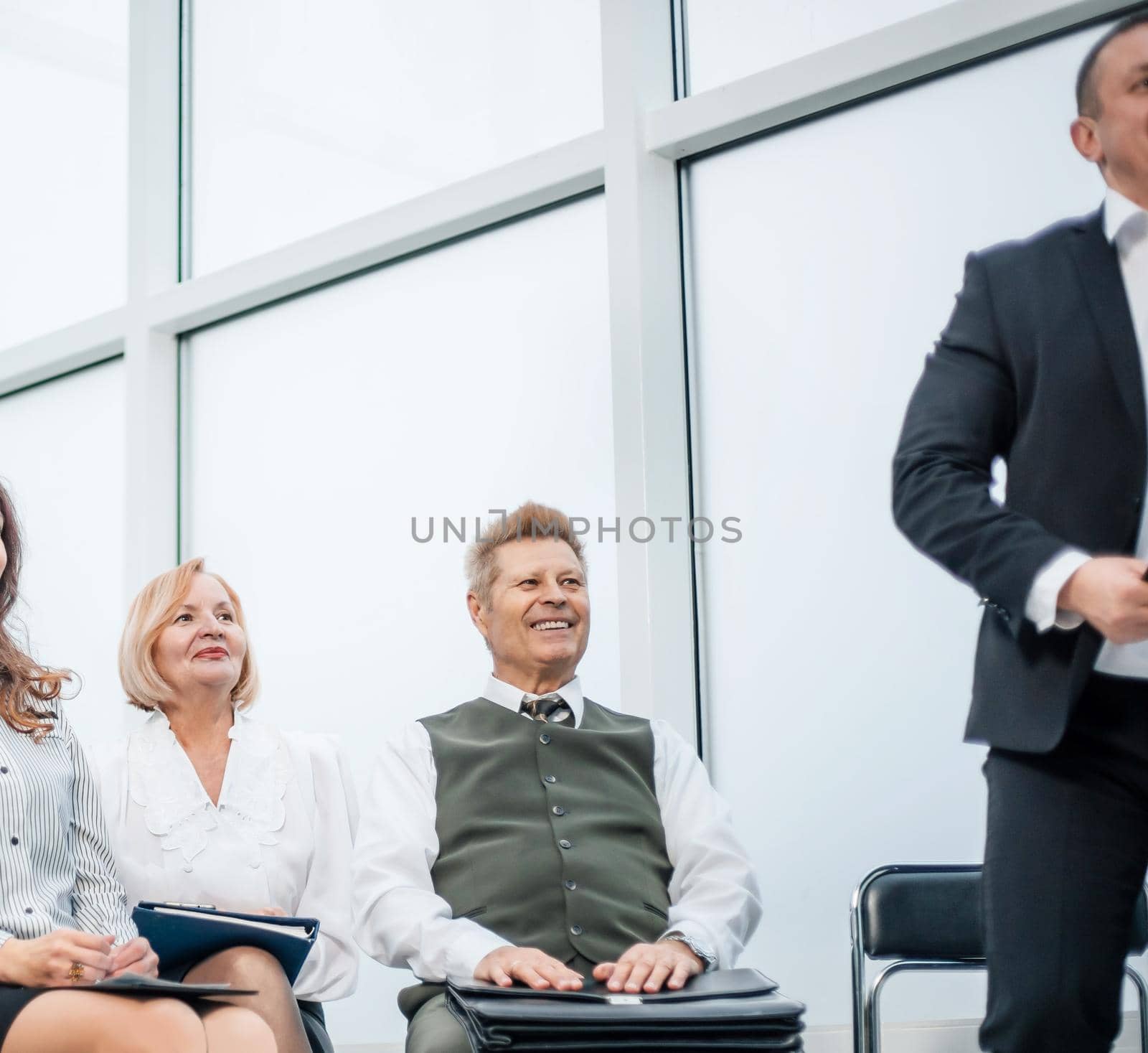 group of responsible business people sitting in the conference room. by SmartPhotoLab