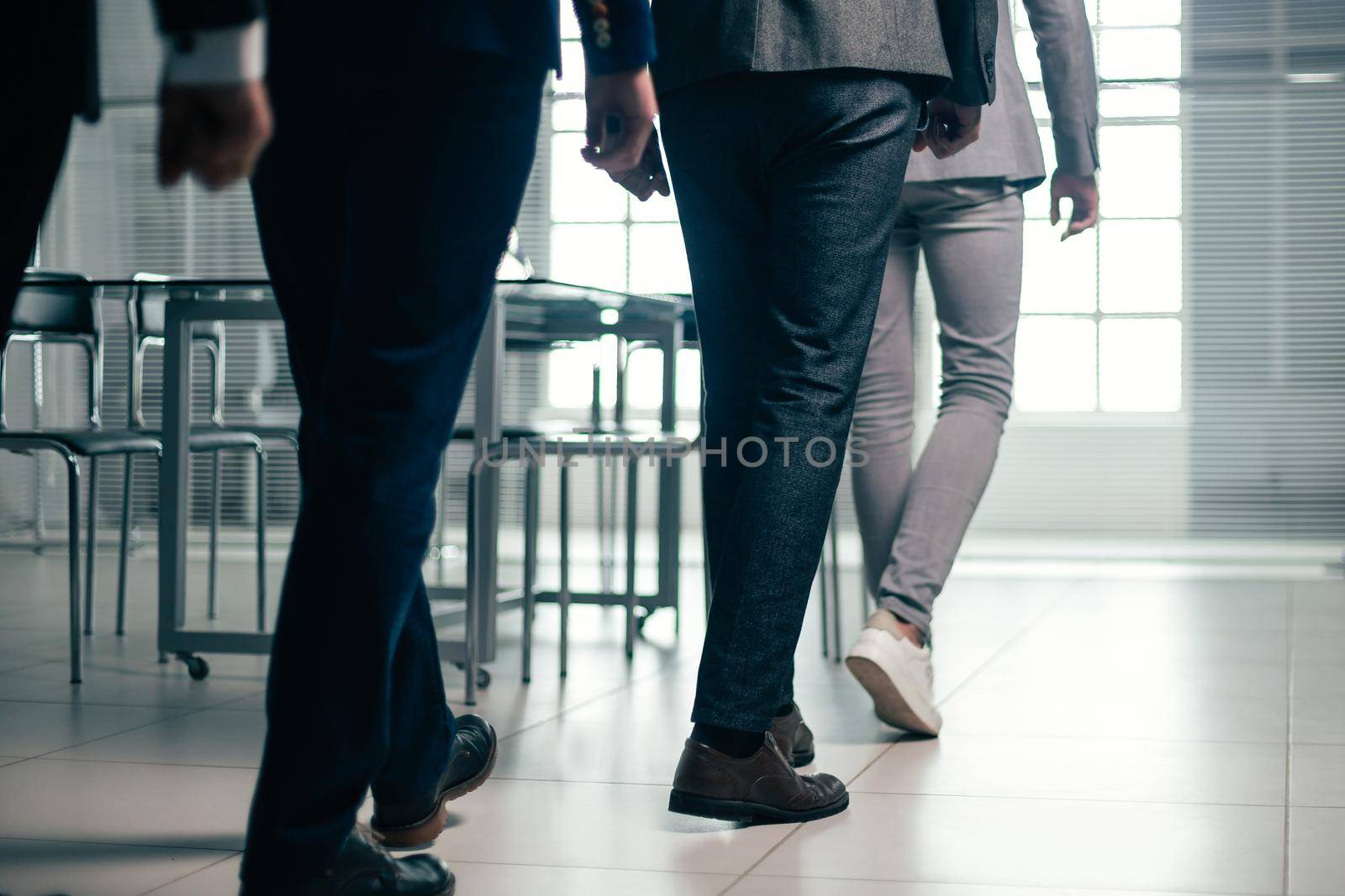 close up. office employees passing to the workplace. business concept