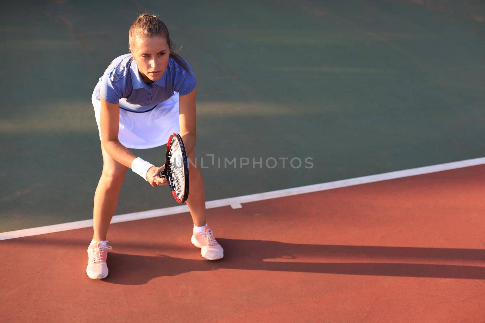 Pretty sportswoman with racquet at the tennis court. Healthy lifestyle. by tsyhun