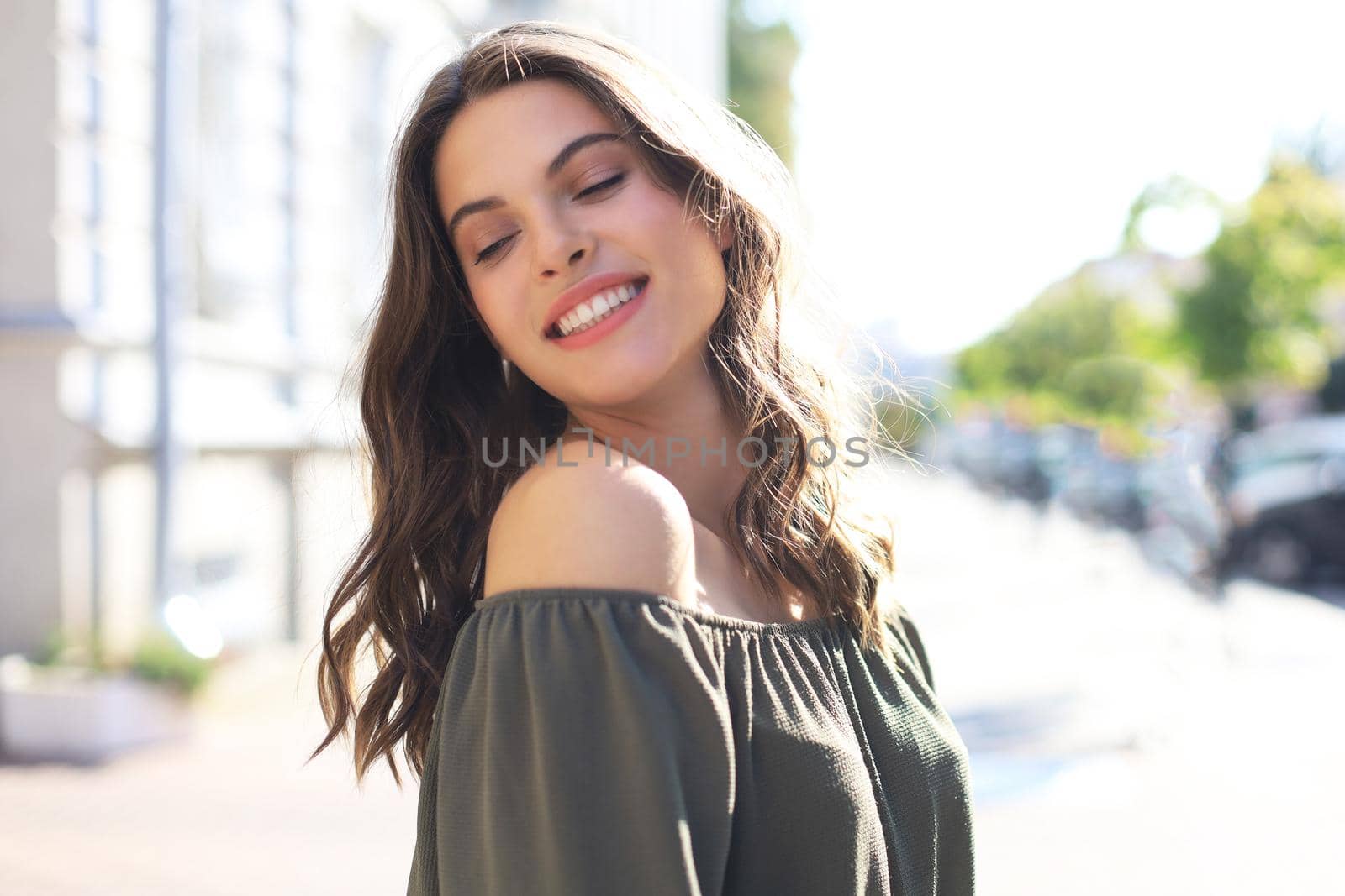 Smiling happy young beautiful woman walking outdoors. by tsyhun