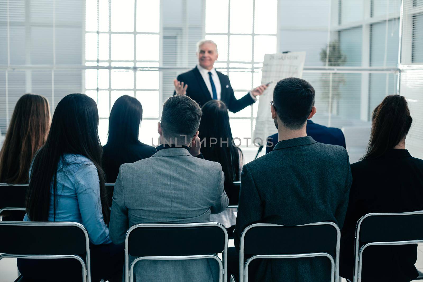 rear view. company employees applauding at a work meeting . success concept