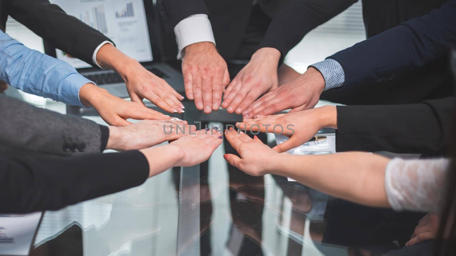 close up. business team joining them in the palm of your hand above the Desk. the concept of teamwork