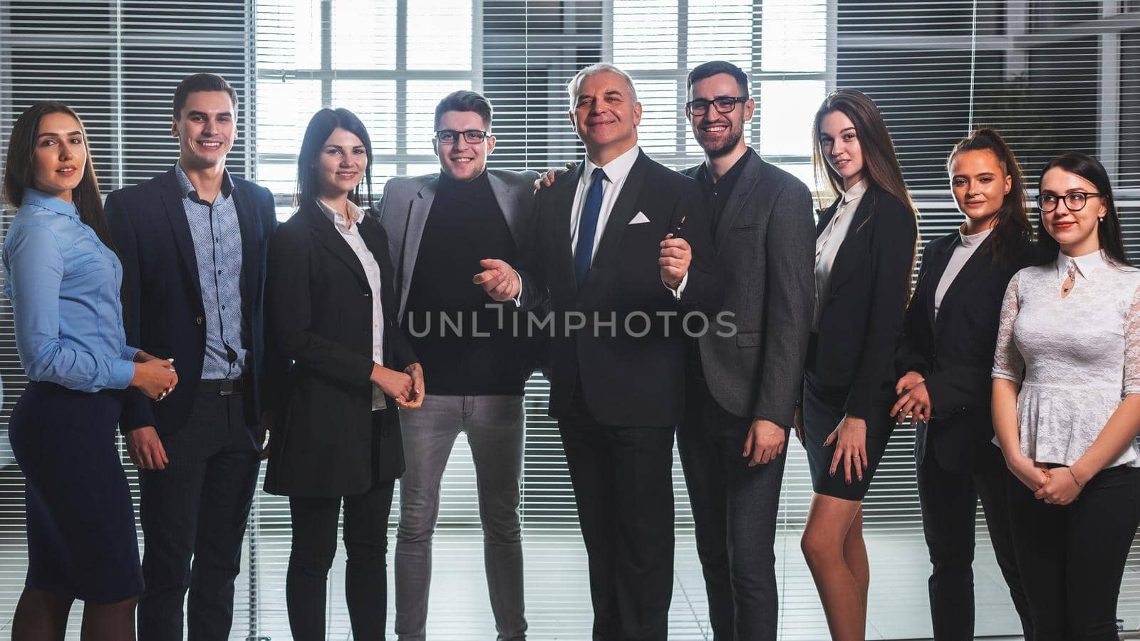 group of happy business people standing in the office lobby. the concept of successful work