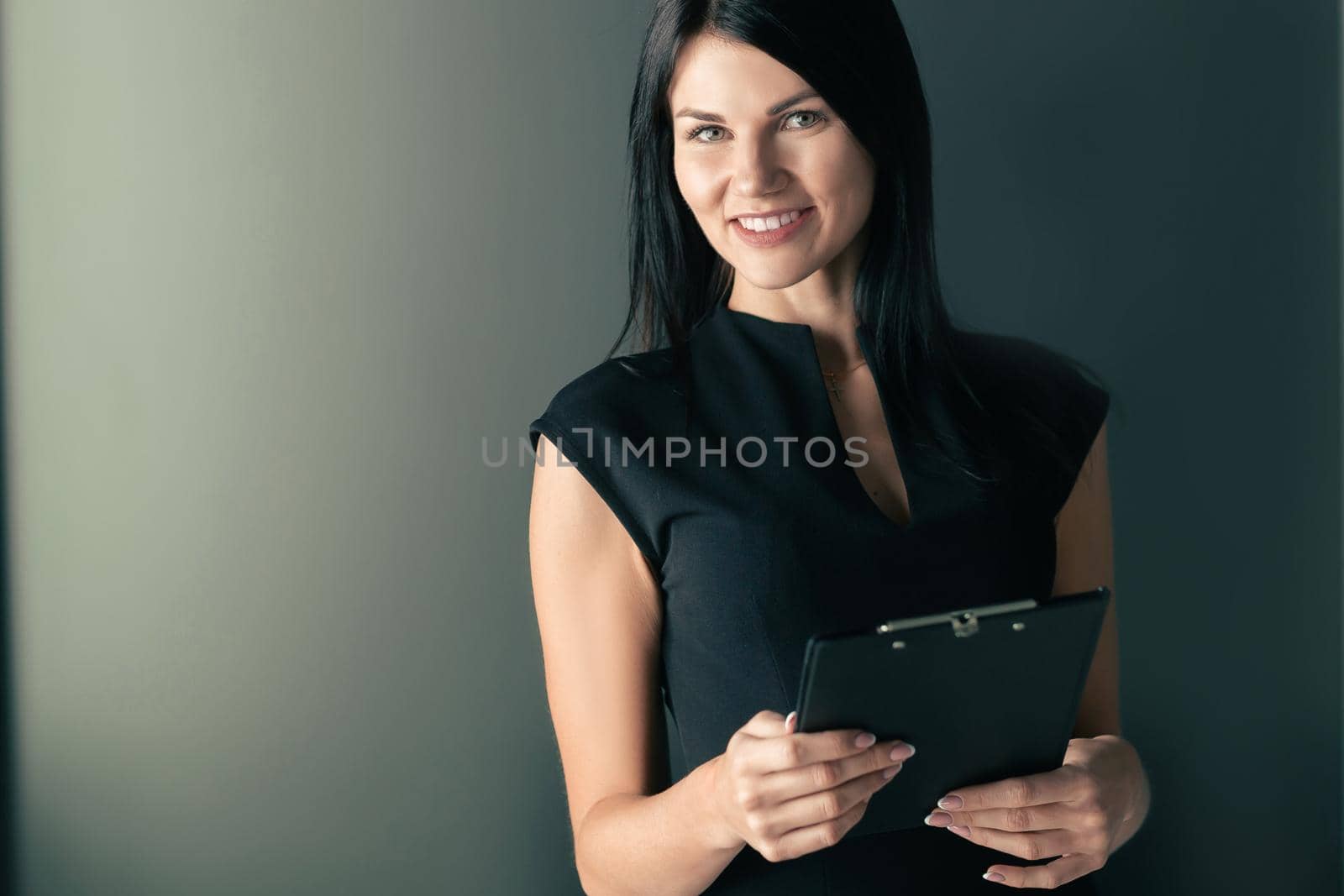 business woman with clipboard standing in office. photo with a copy of the space