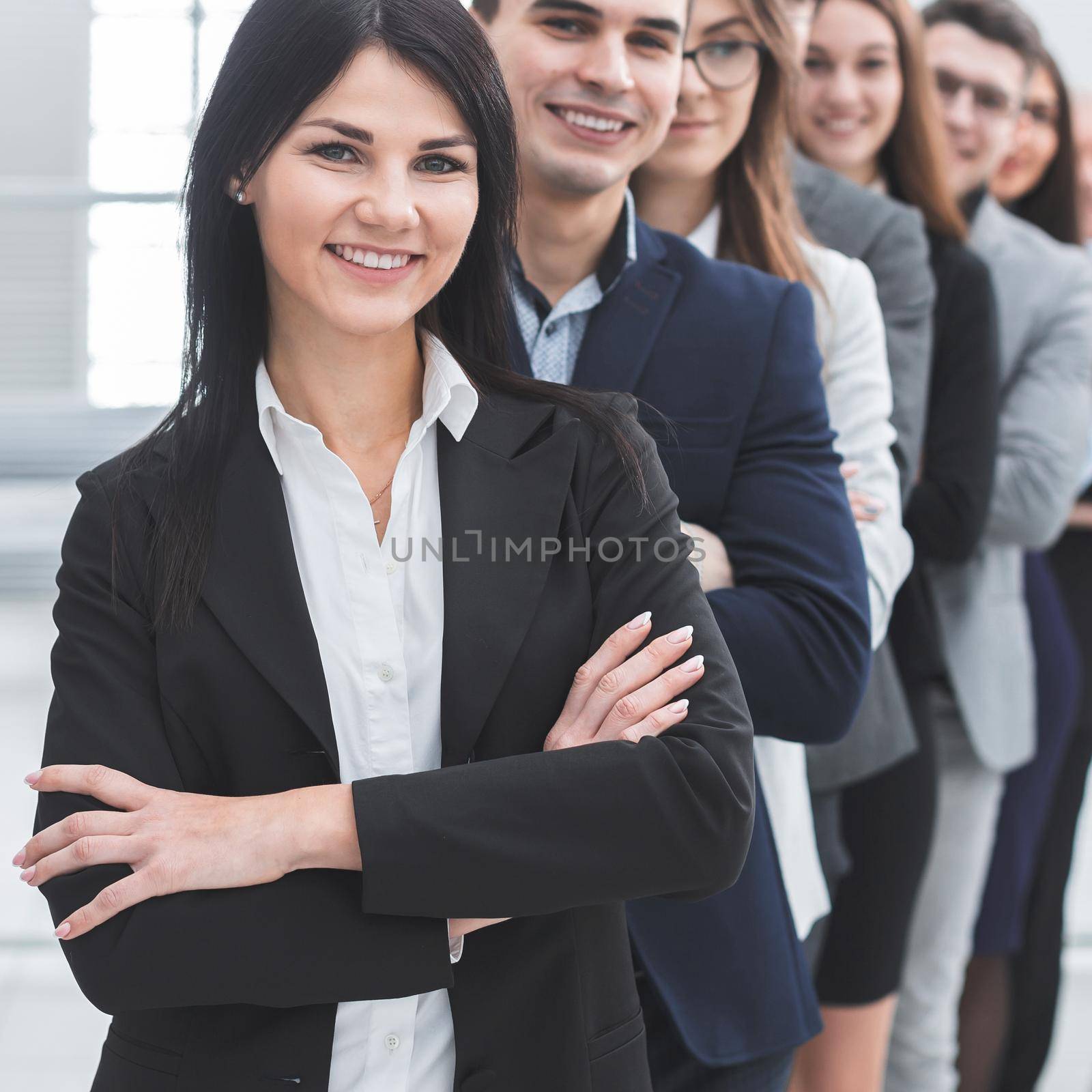 group of confident young people standing in a row by SmartPhotoLab