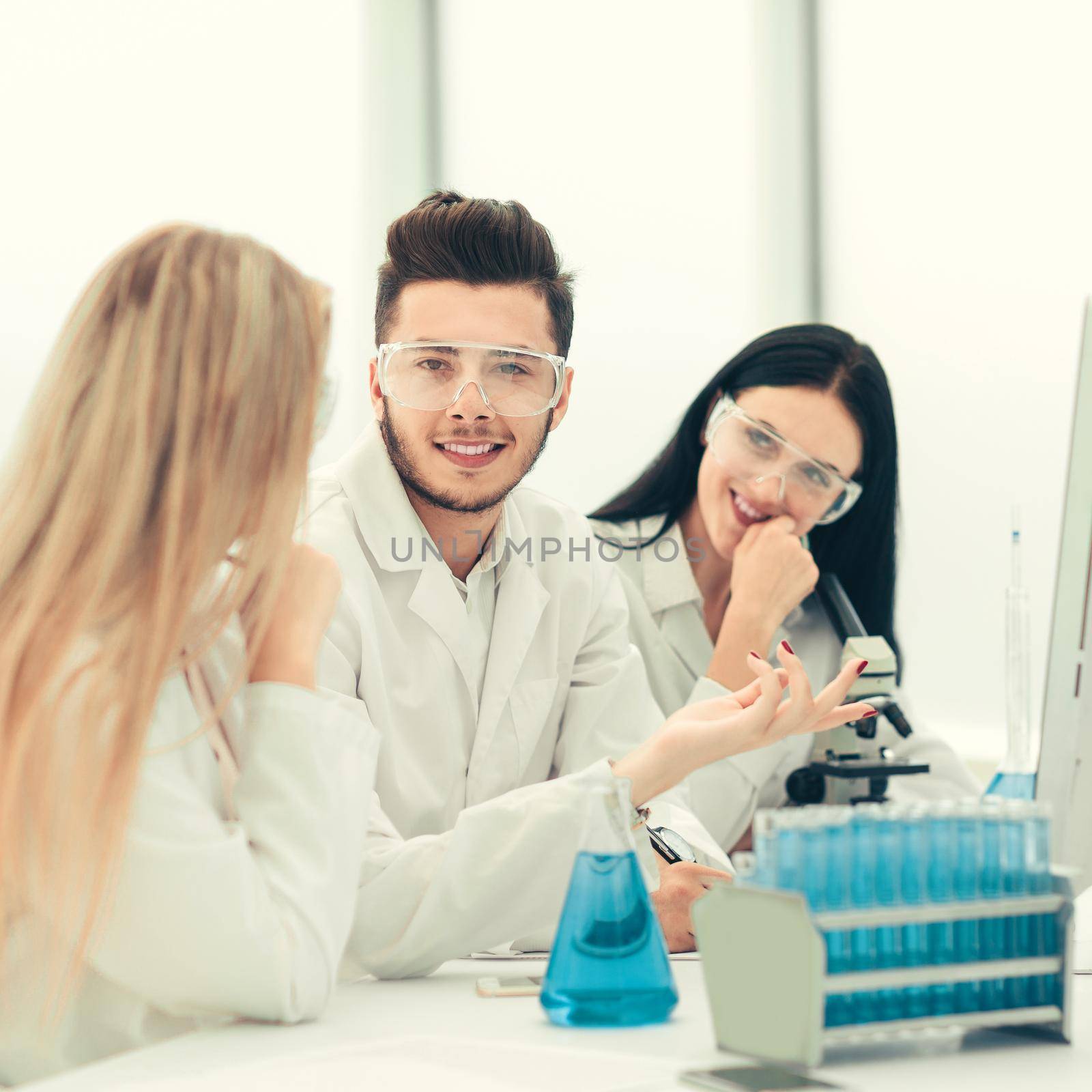 close up.a team of scientists discussing something at the Desk . science and health