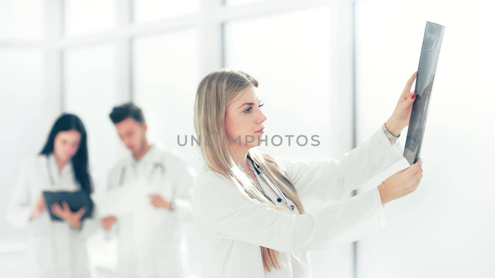 physician therapist looking at the x-ray of the patient. photo with copy space