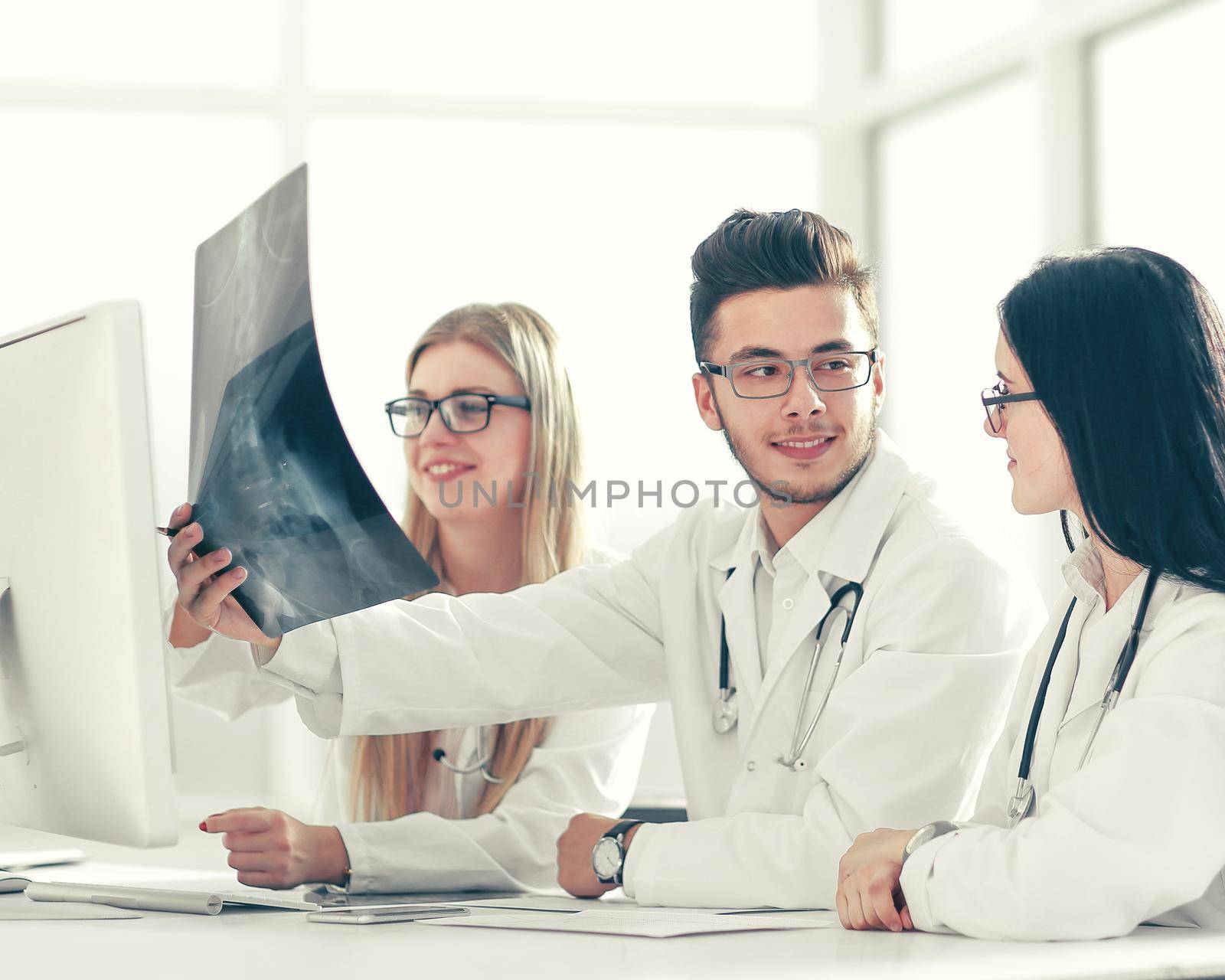 doctors experts discuss x-ray,sitting at the table .photo with copy space