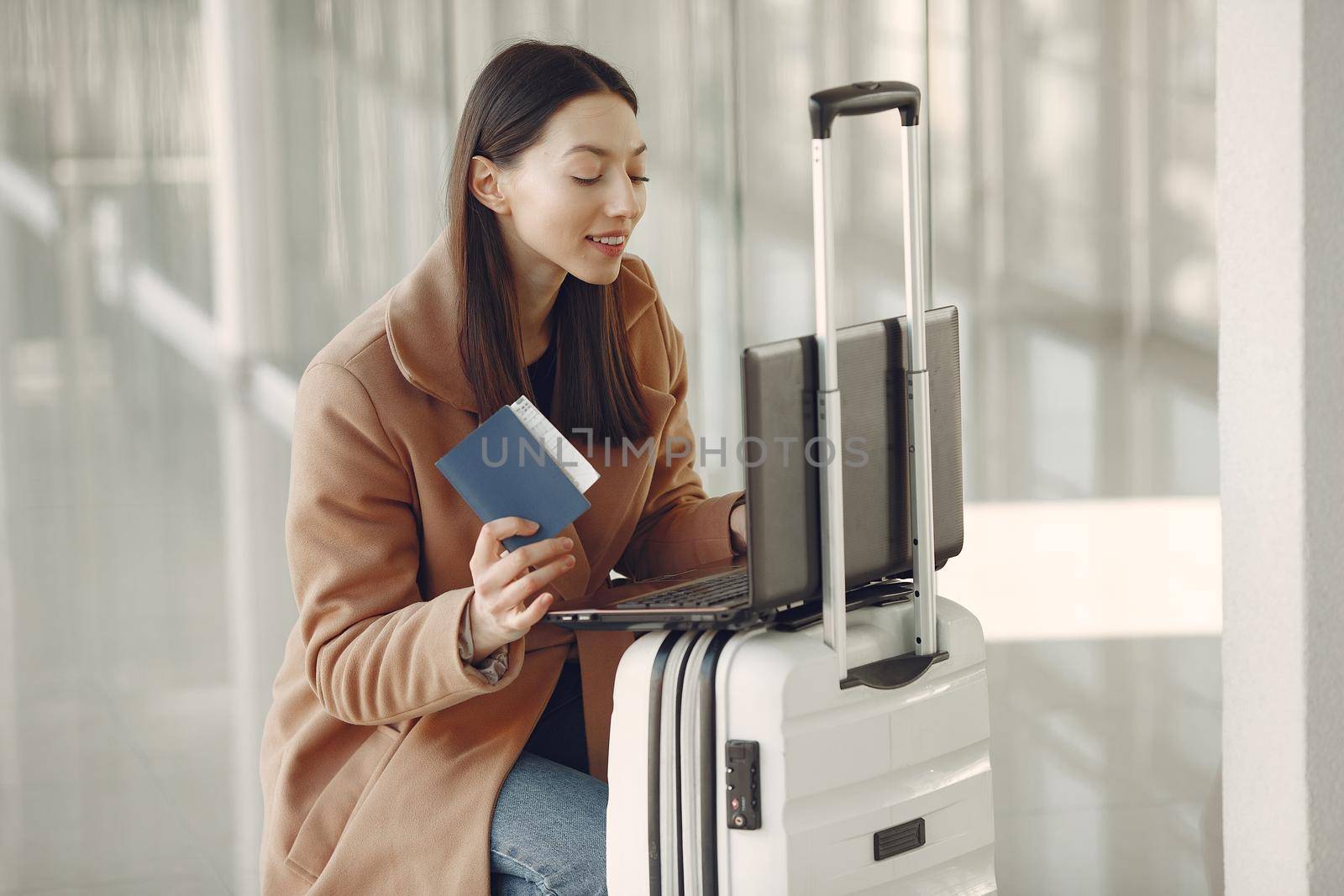 Woman with suitcase at the airport by prostooleh