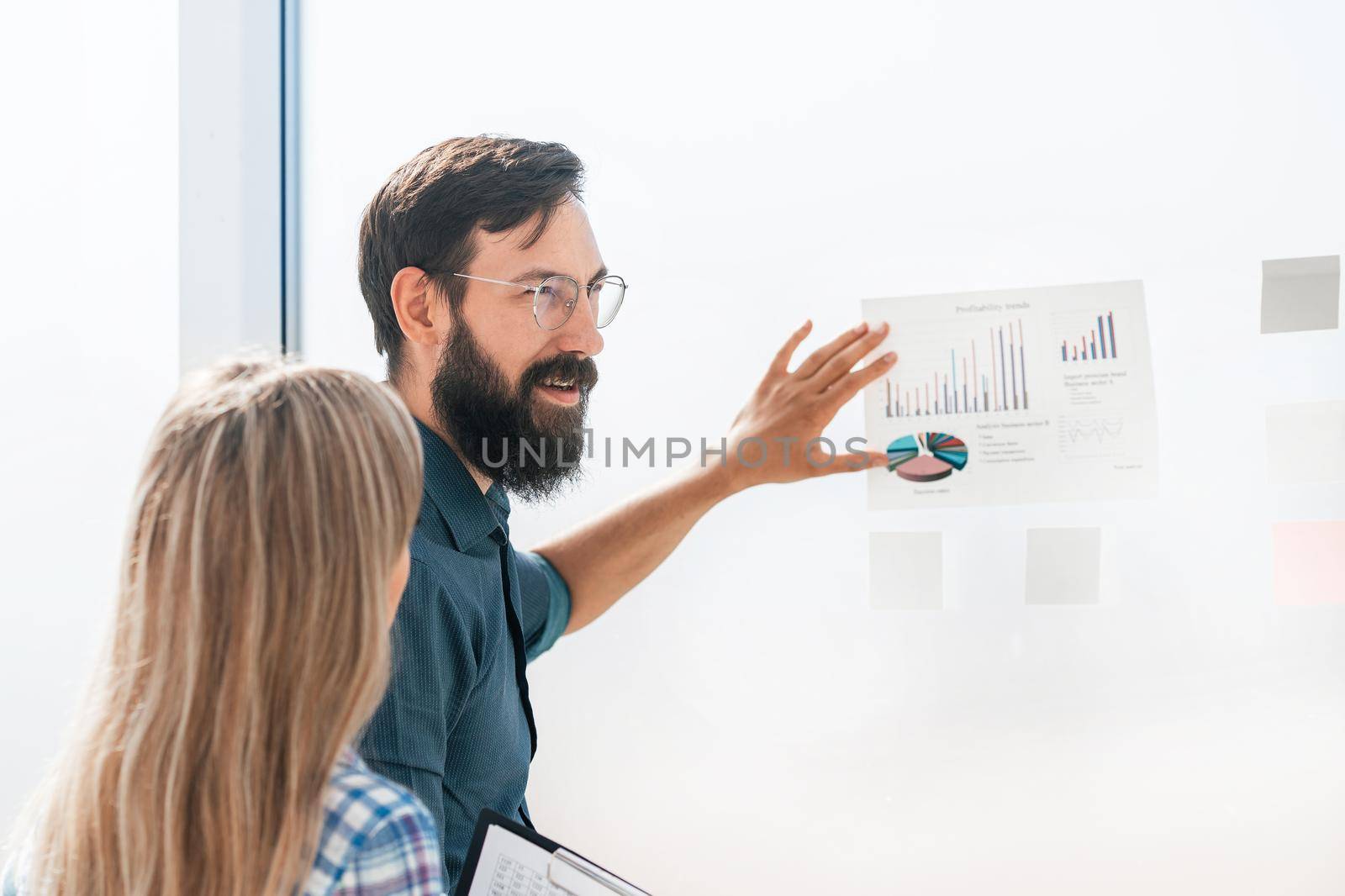 businessman standing near the Board with a financial schedule. business concept