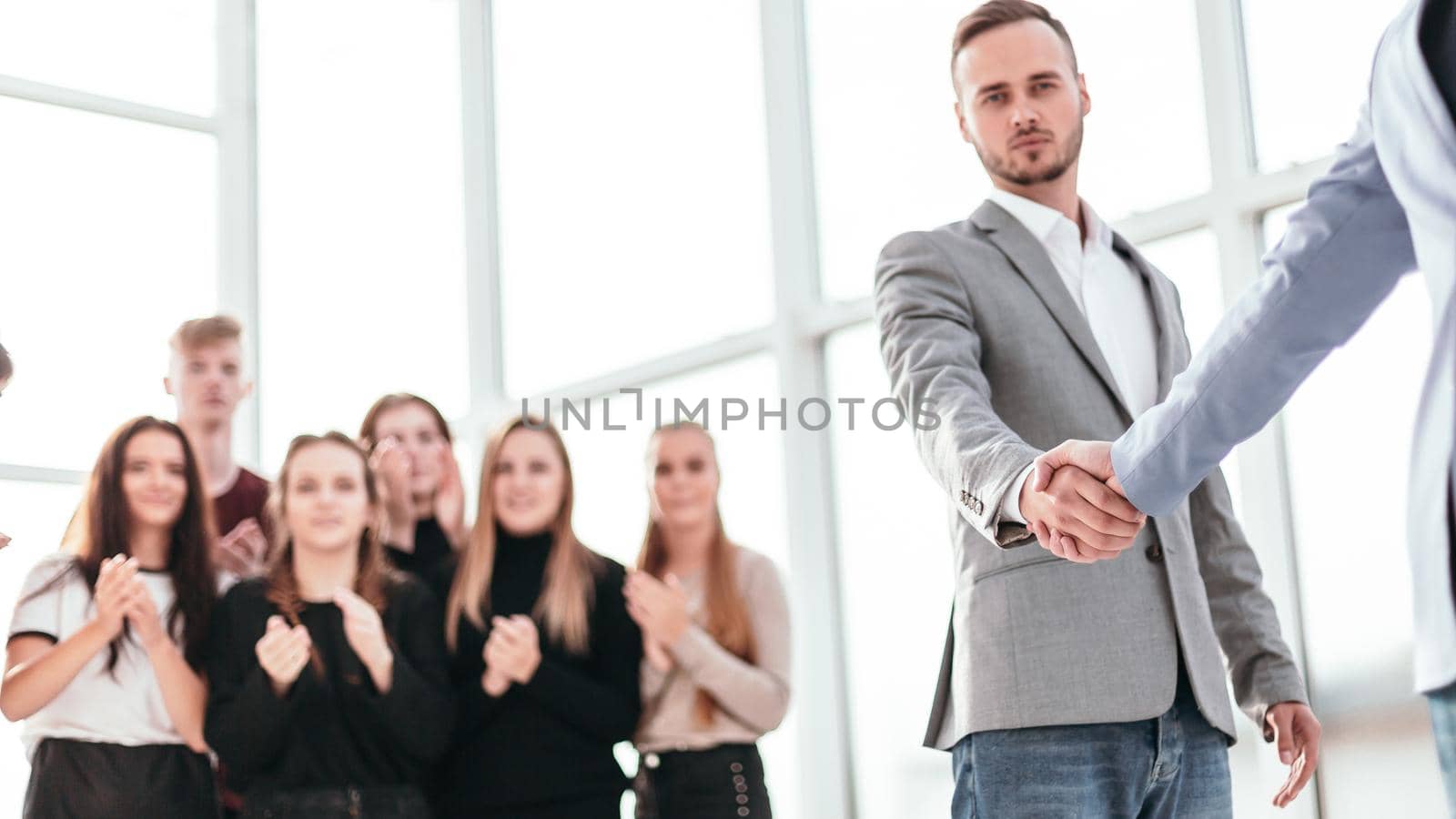 close up. serious young men shaking hands. photo with copy space