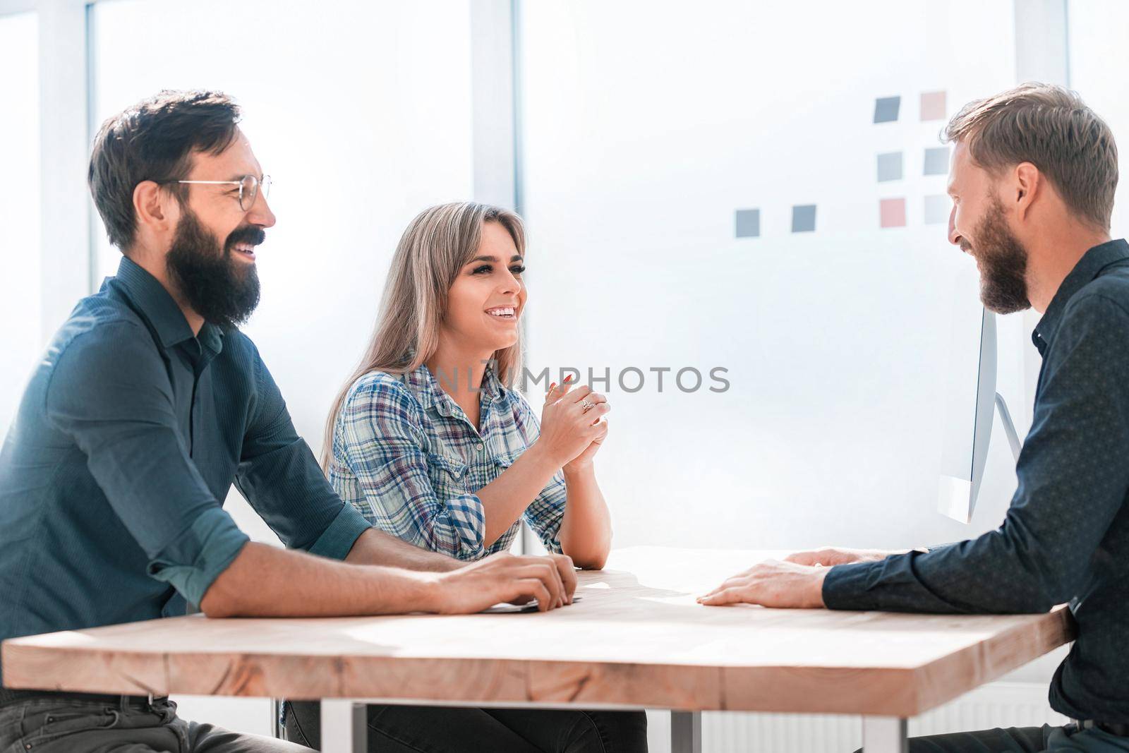group of young employees sitting at the Desk. by SmartPhotoLab