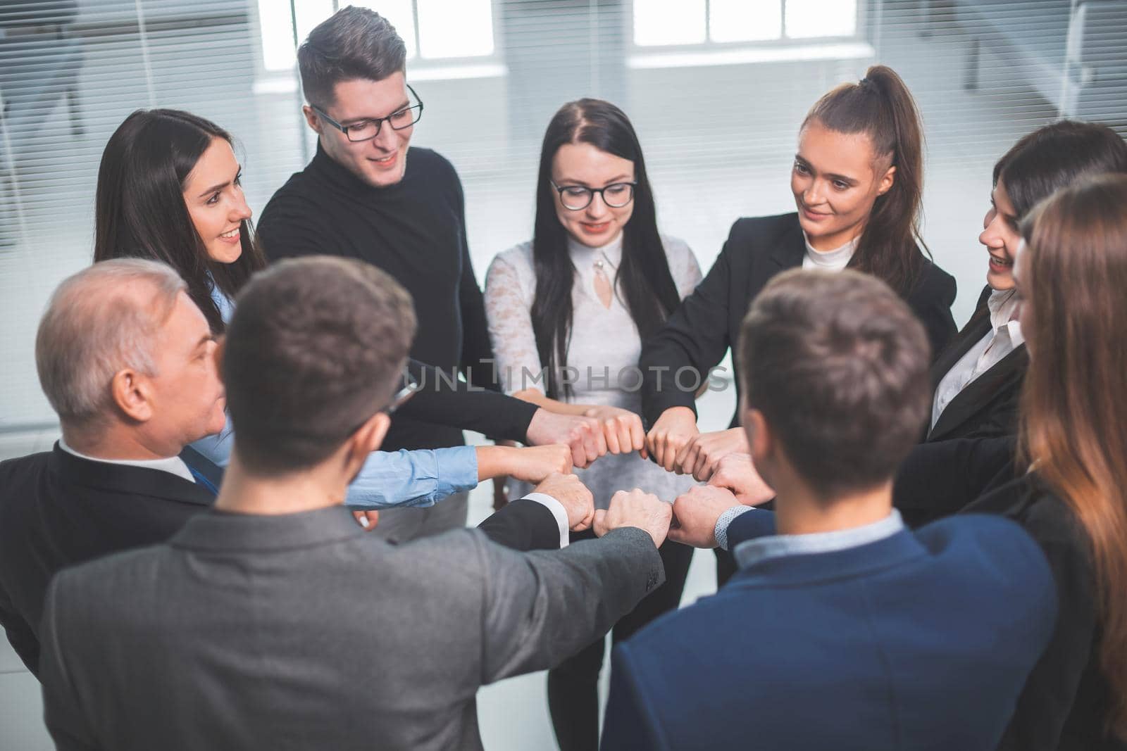 close up. a team of young professionals standing in a circle. the concept of teamwork