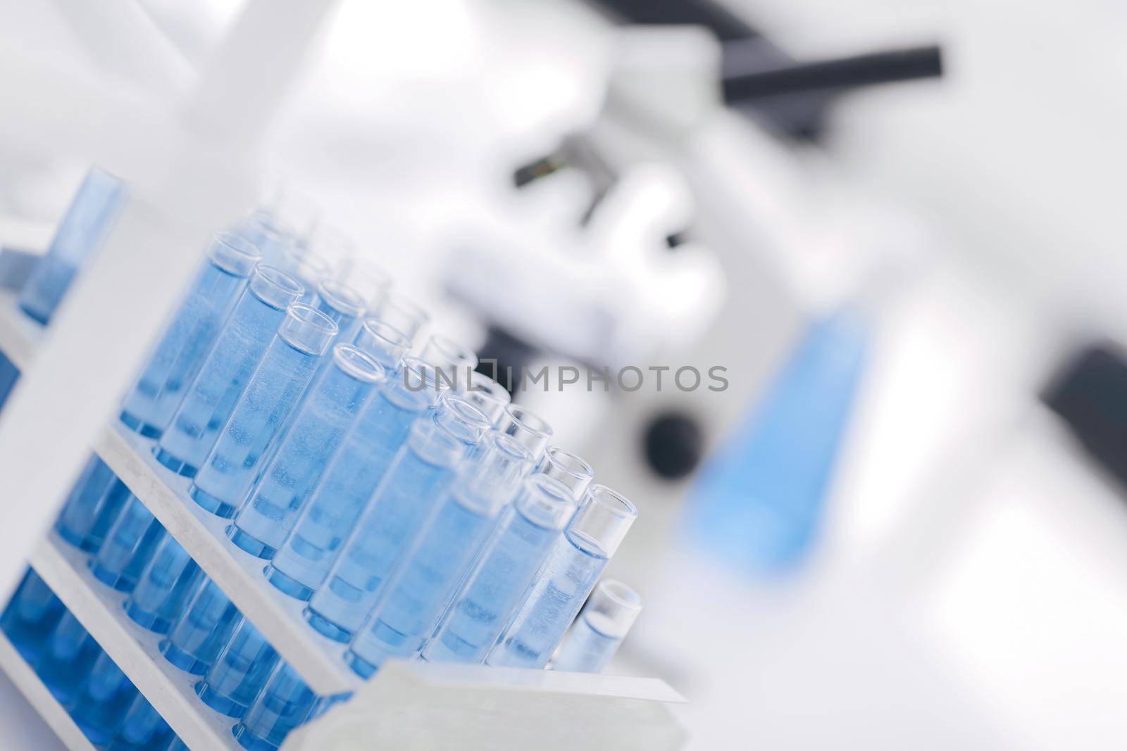 laboratory glass.close up. tubes of blue liquid in the science lab