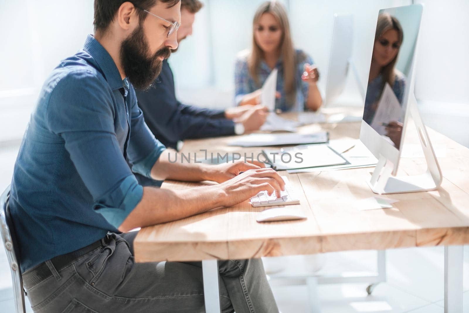 businessman uses a computer in the workplace in the office. people and technology