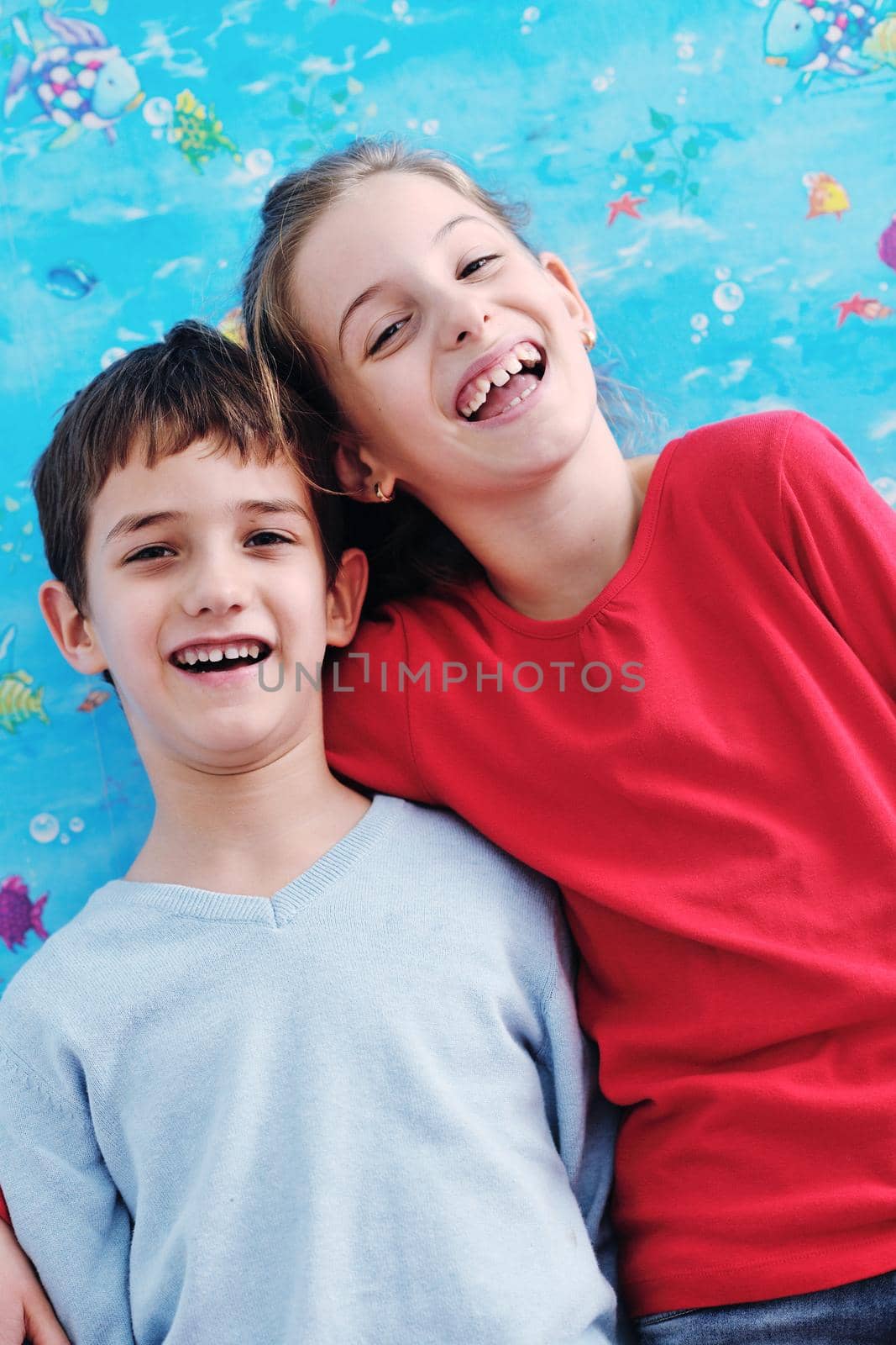 happy child kids portrait at home brother and sister hug and have fun and joy
