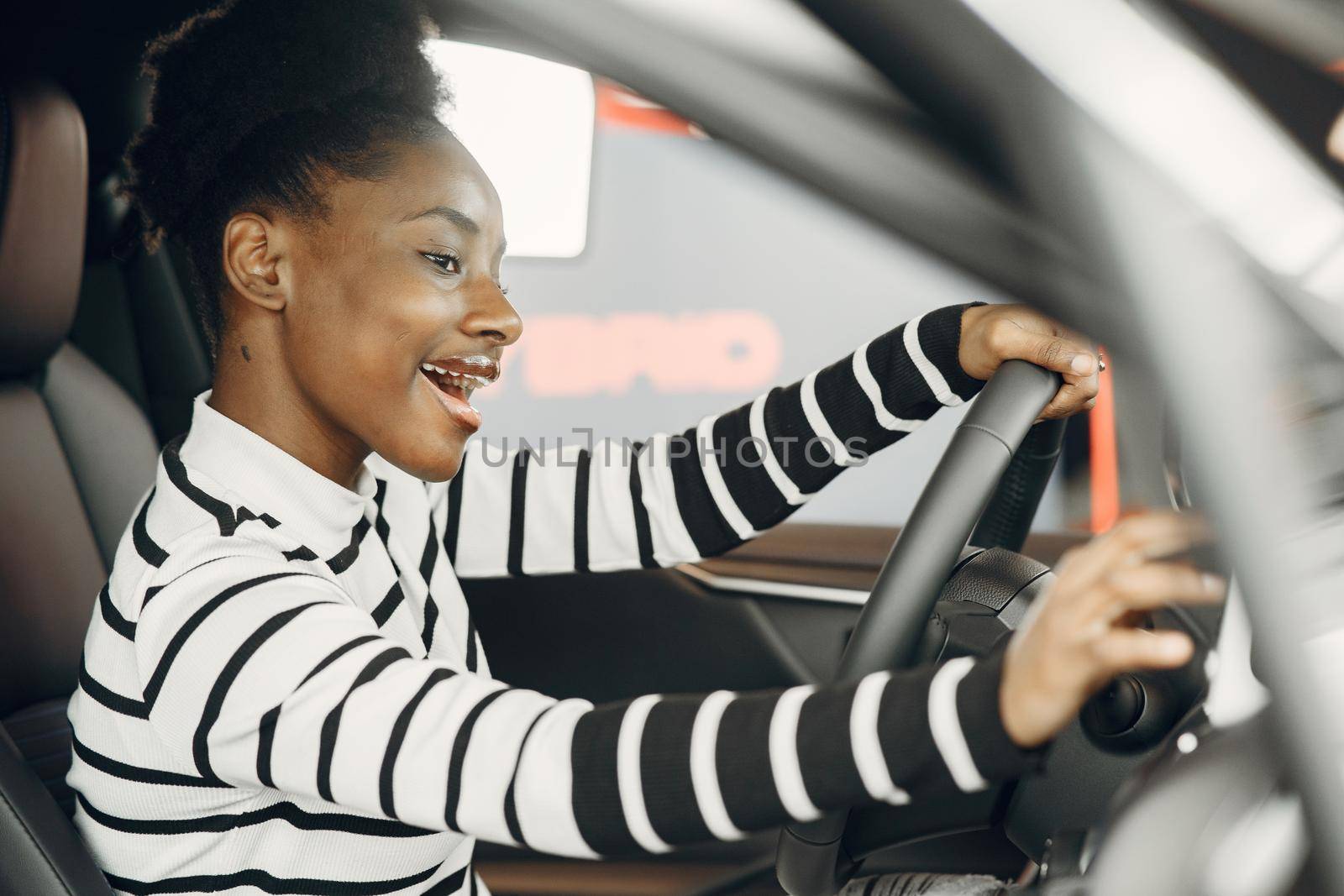 Went shopping today. Shot of an attractive African woman sitting in a car salon.