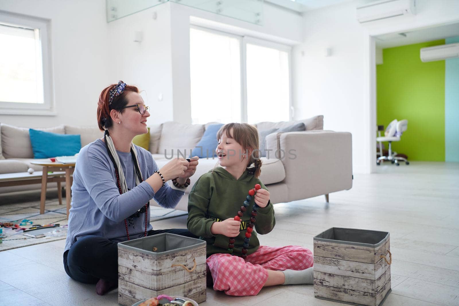 Mother and little girl daughter playing with jewelry  at home by dotshock