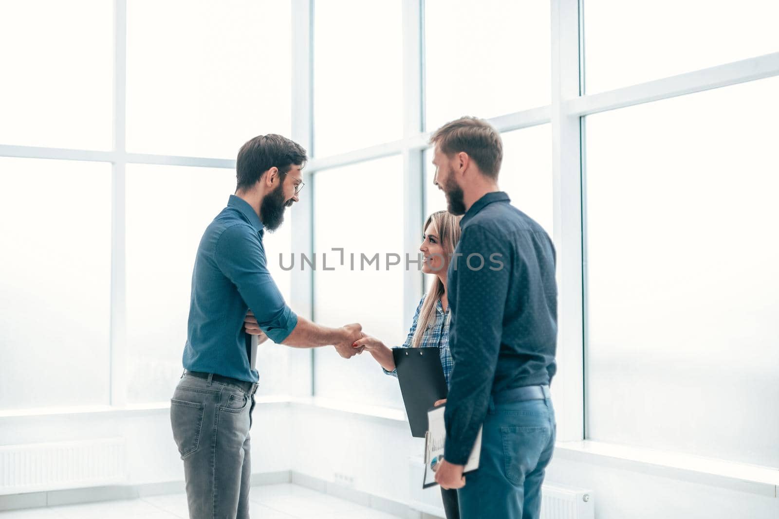 young entrepreneurs shaking hands with each other . concept of cooperation