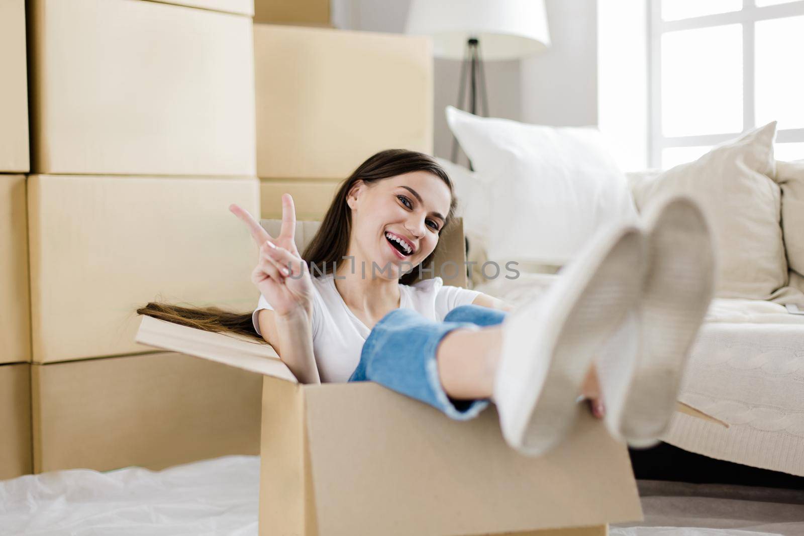 close up. happy young woman sitting in a large cardboard box