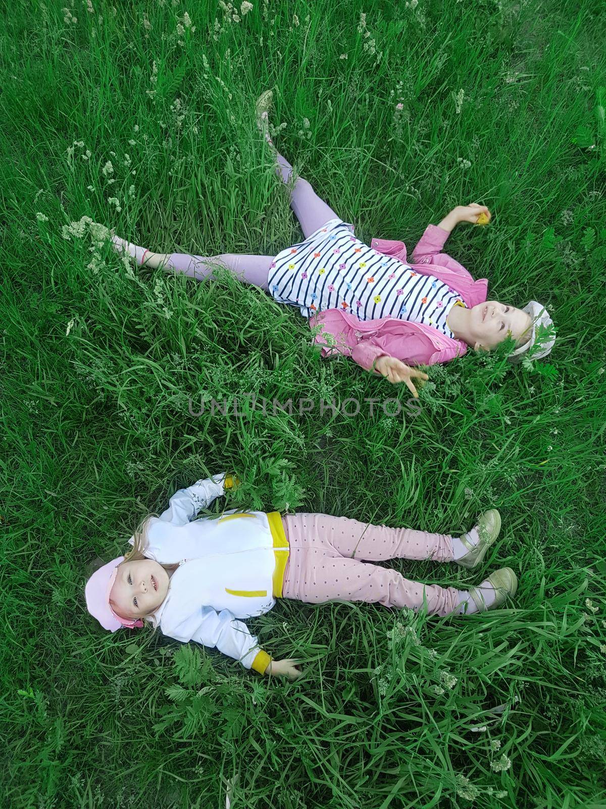 top view. happy kids lying on the grass and enjoying nature.