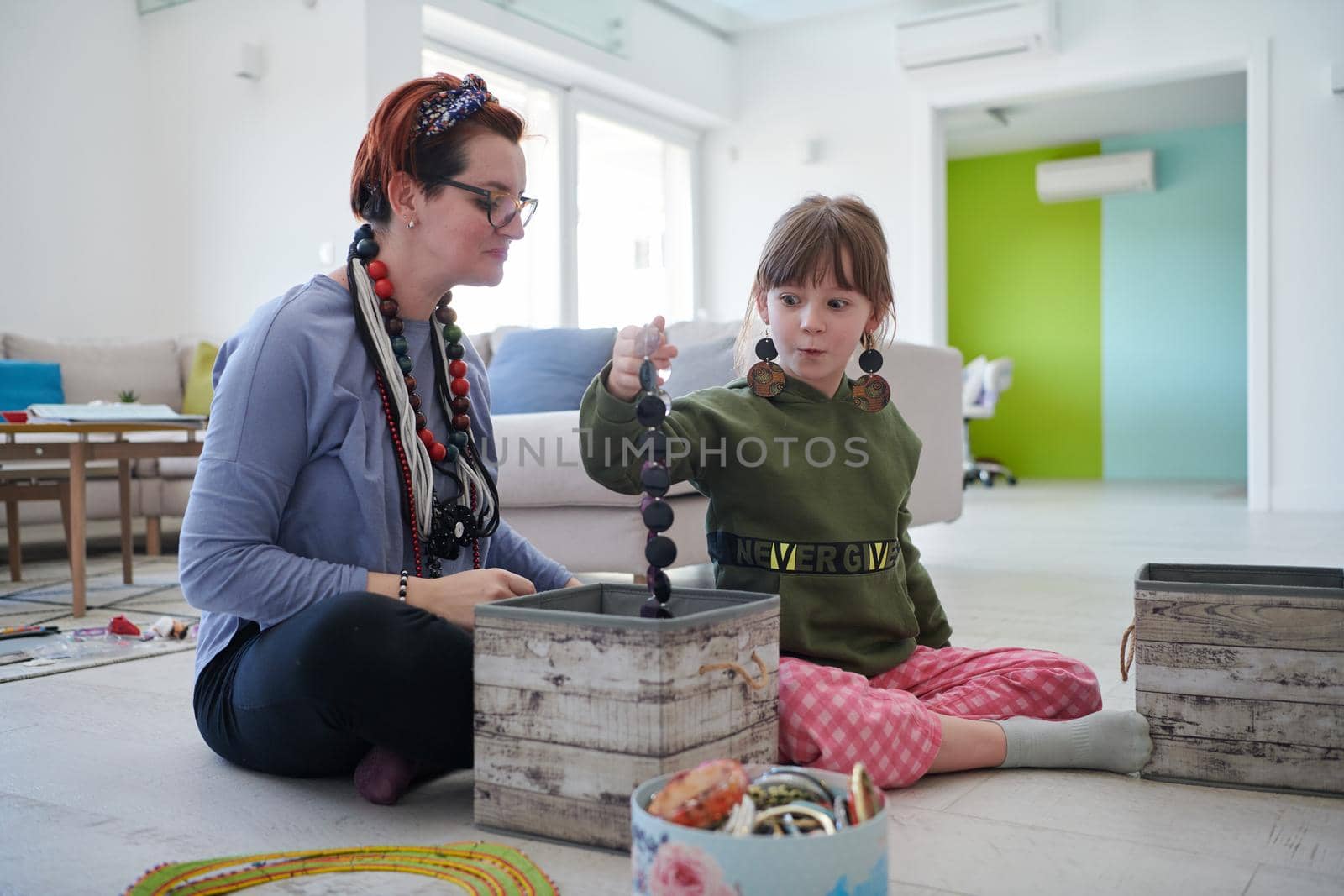 Mother and little girl daughter playing with jewelry  at home by dotshock