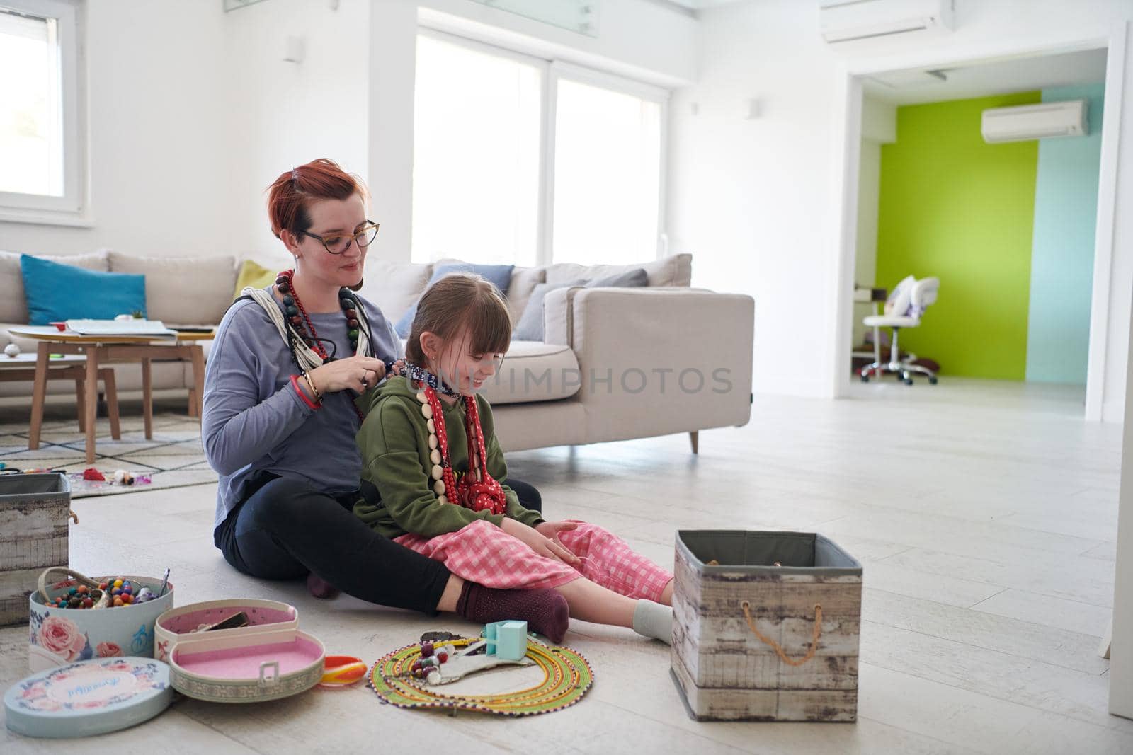 Mother and little girl daughter playing with jewelry  at home by dotshock