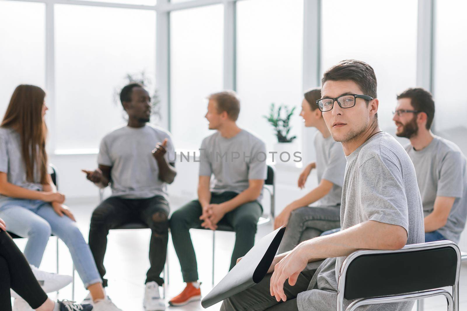 handsome guy sitting in a circle with like-minded person. business and education